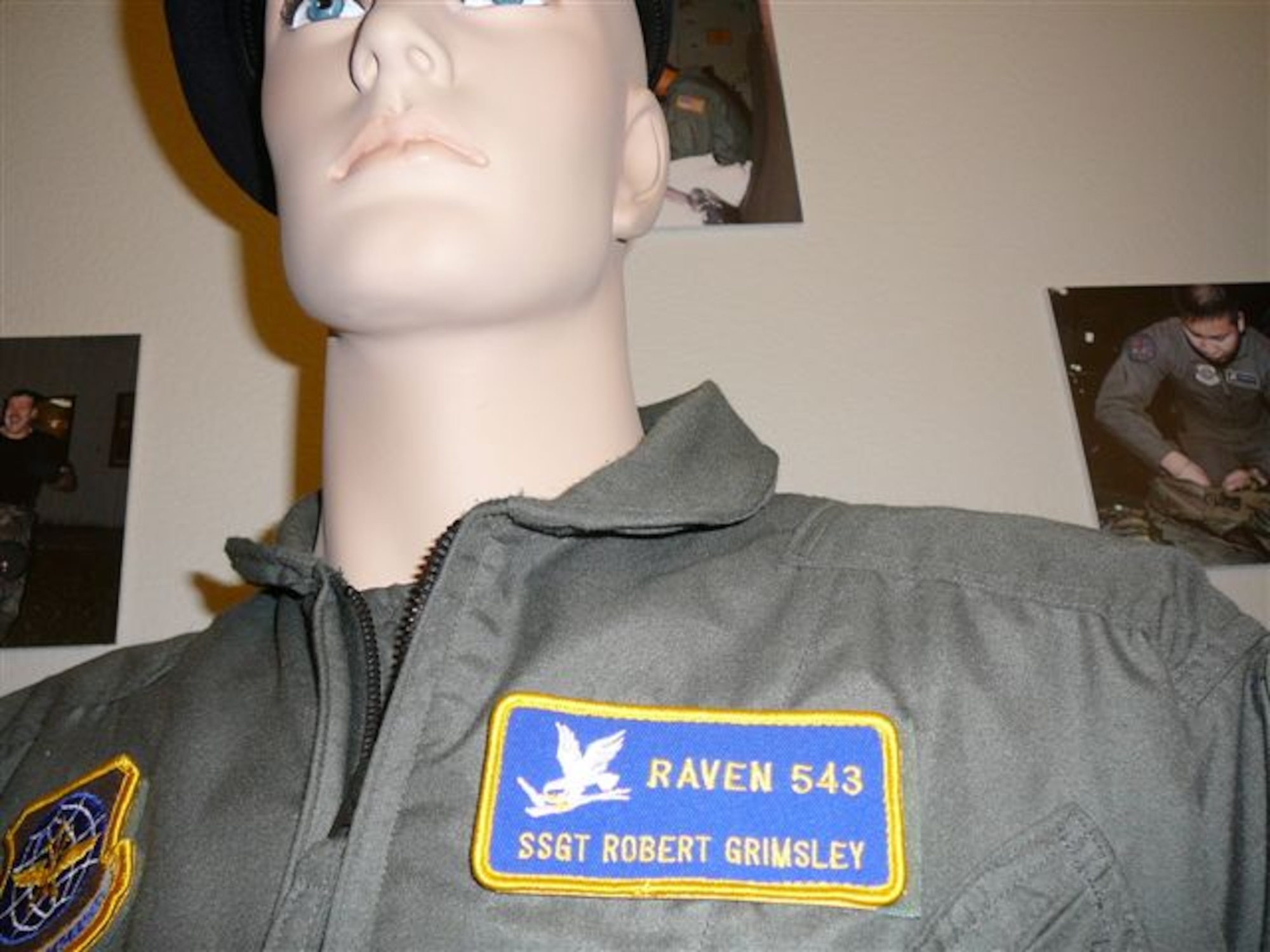A flight suit and badge belonging to Master Sergeant Robert Grimsley, Raven 543, 315th Airlift Wing, Charleston Air Force Base S.C. is displayed at the U.S. Air Force Security Forces Museum, Lackland Air Force Base Texas. Each graduate of the Phoenix Raven Program recieves a number sepefic only to that Raven and will not be reissued, even after the member retires.(U.S. Air Force Photo/Maj. Kevin Stegall)