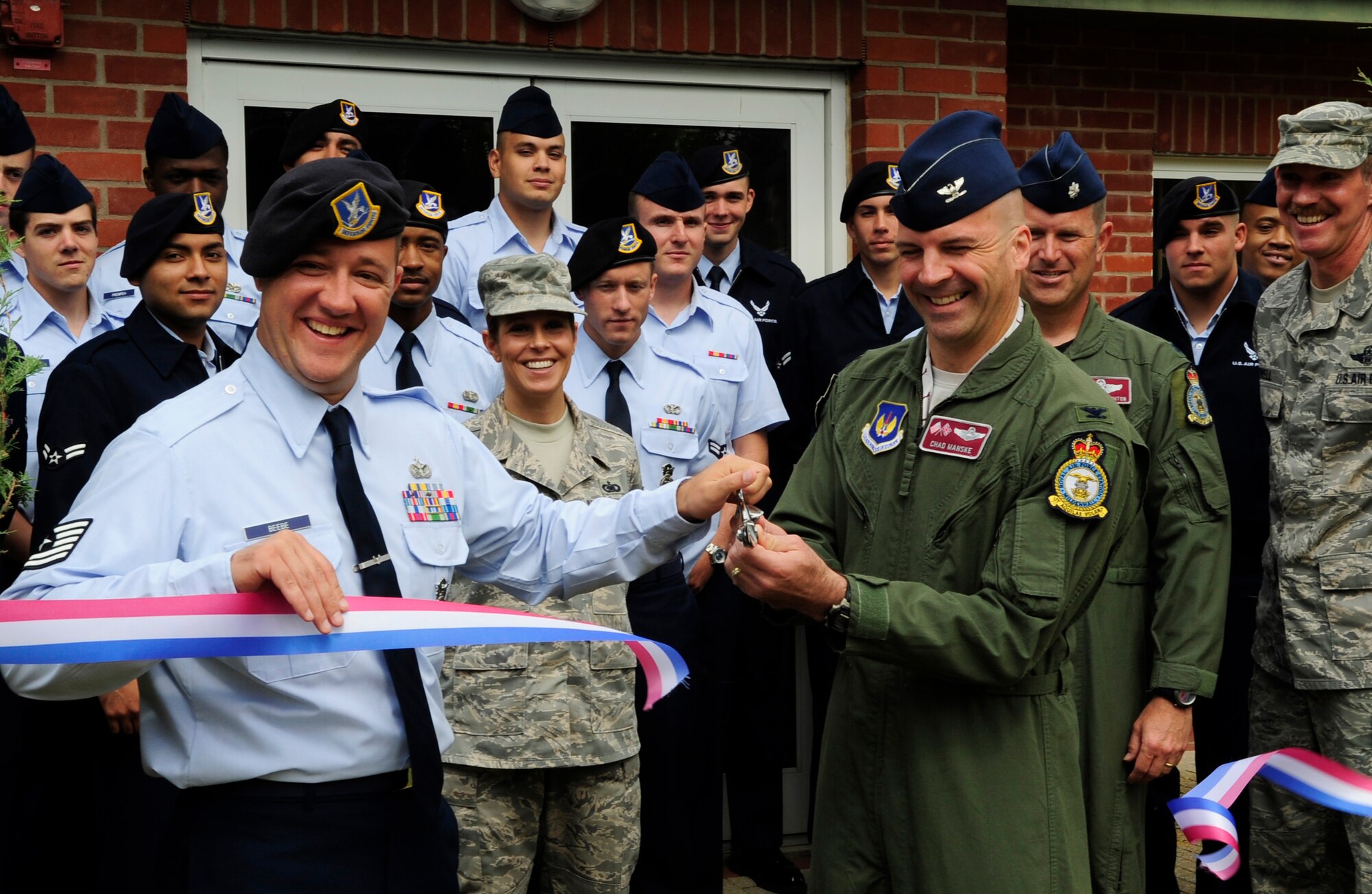 RAF MILDENHALL, England – Col. Chad Manske, 100th Air Refueling Wing commander, and Tech. Sgt. Nicholas Beebe, Noncommissioned Officer in Charge of the First-Term Airmen Center, cut the ceremonial ribbon at Building 670 June 7. The building will house FTAC and the Sexual Assault Response Coordinator.  Building 670, once the multimedia center, has been vacant since 2008, and has been repainted and refurnished to accommodate its new mission.  (U.S. Air Force photo/Staff Sgt. Christopher L. Ingersoll)