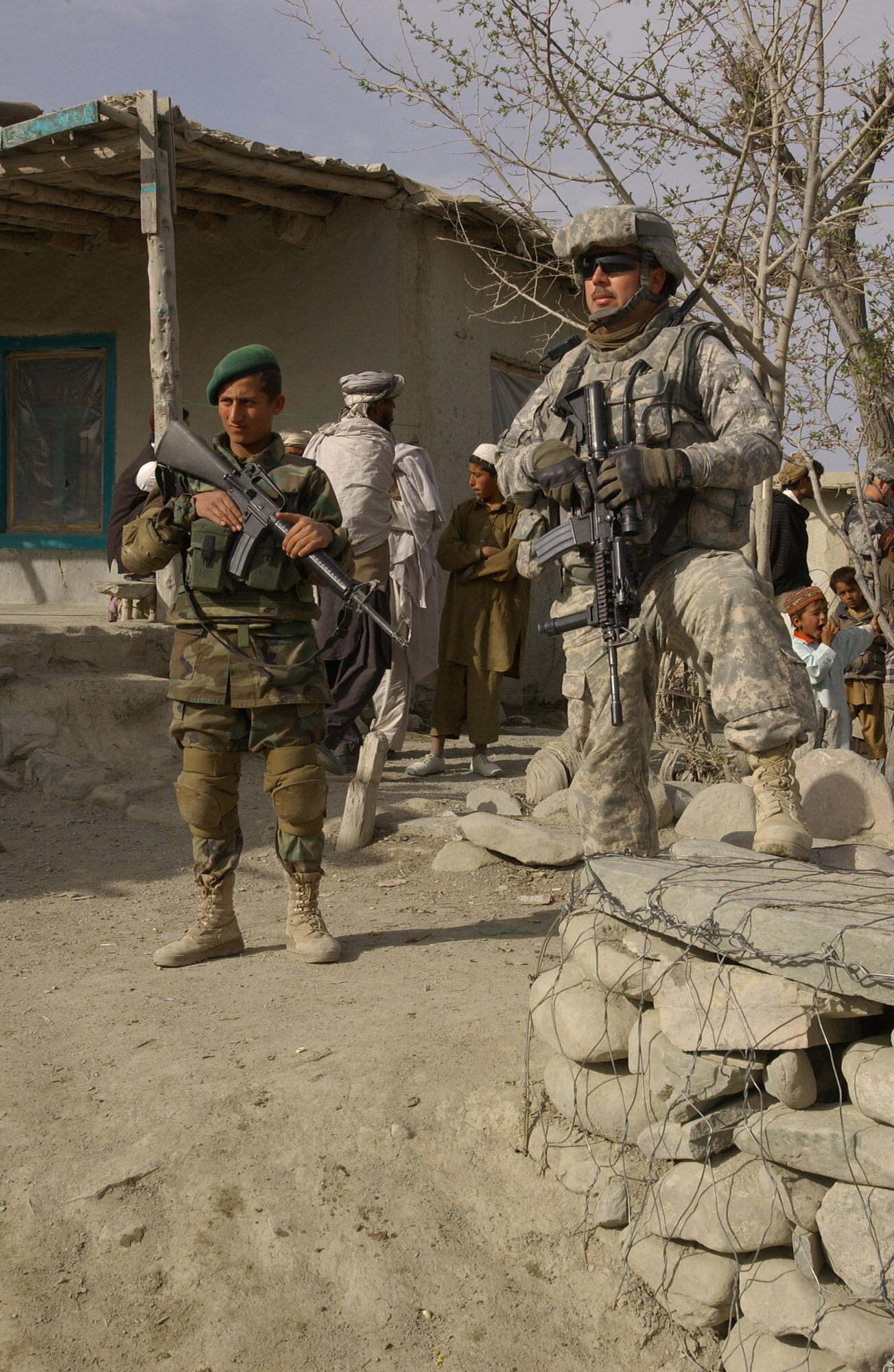U.S. Army Sgt. Allen Huey, from Mountville, S.C., provides security during a key leader engagement in Orgun district with help from a member of the Afghan National Army. Huey and his team, formerly field artillery specialists, are serving as the security force element for the Paktika Provincial Reconstruction Team in eastern Afghanistan. Huey is deployed from the B/1-178th Field Artillery Regiment, South Carolina Army National Guard. The Paktika PRT is a joint team that assists in the reconstruction of the province through governance, development and agricultural initiatives. (Photos by U.S. Air Force Master Sgt. Demetrius Lester, Paktika Provincial Reconstruction Team Public Affairs)                               