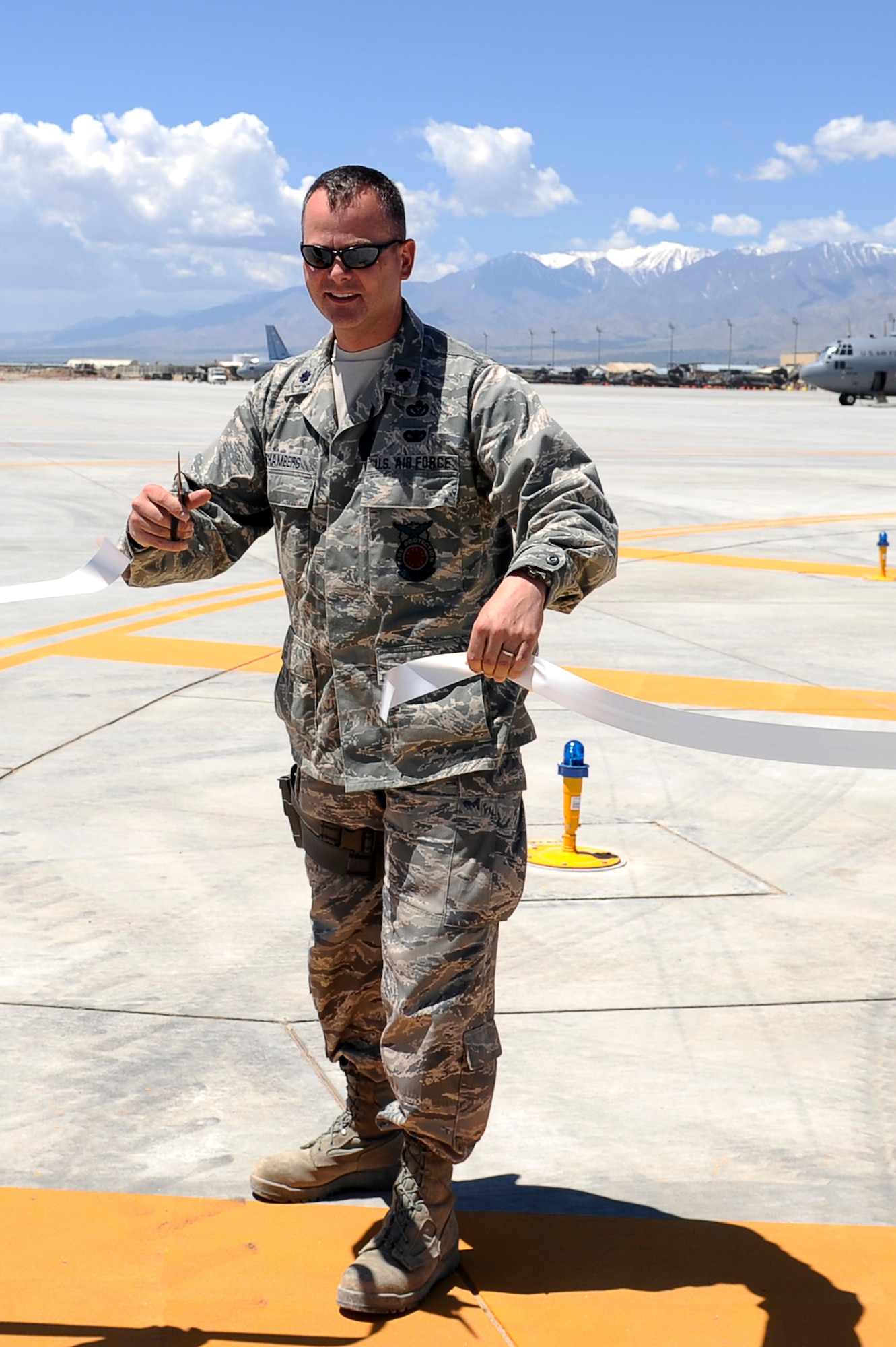 U.S. Air Force Lt. Col. Scott Chambers, commander, 455th Expeditionary Civil Engineer Squadron, cuts the ribbon to open the new Sierra Ramp at Bagram Airfield, Afghanistan, June 4, 2010. Colonel Chambers is deployed from the Minnesota Air National Guard, and is from Cottage Grove, Minn. (U.S. Air Force photo by/ Master Sgt. Jeromy K. Cross/released)








