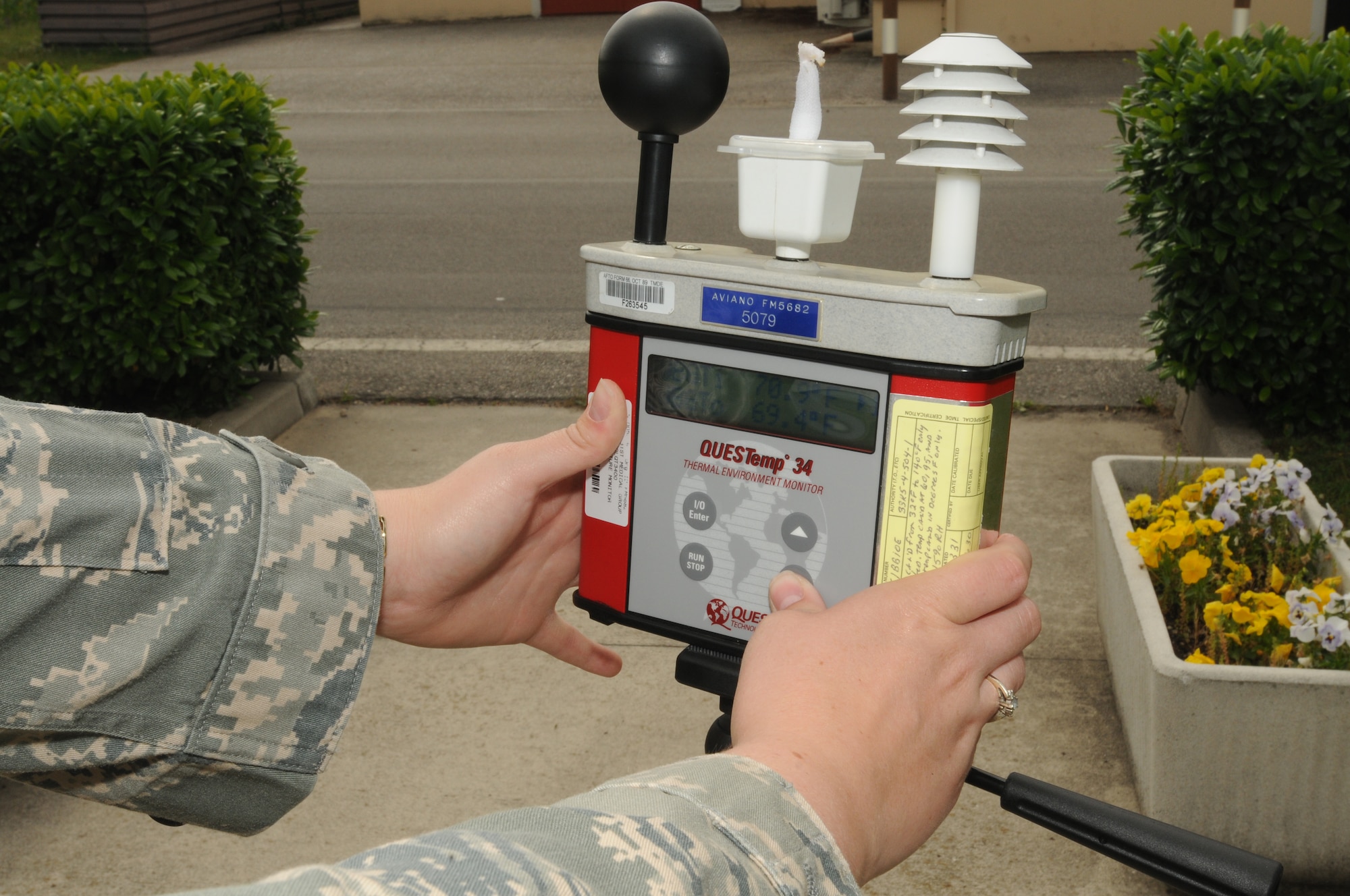 Senior Airman Kathleen Coop, 31st Aerospace Medicine Squadron bioenvironmental technician, checks the wet bulb dry temperature meter at bioenvironmental engineering, June 4.  This instrument is used to determine the Aviano heat stress conditions.  (U.S. Air Force photo/Senior Airman Tabitha M. Mans)
