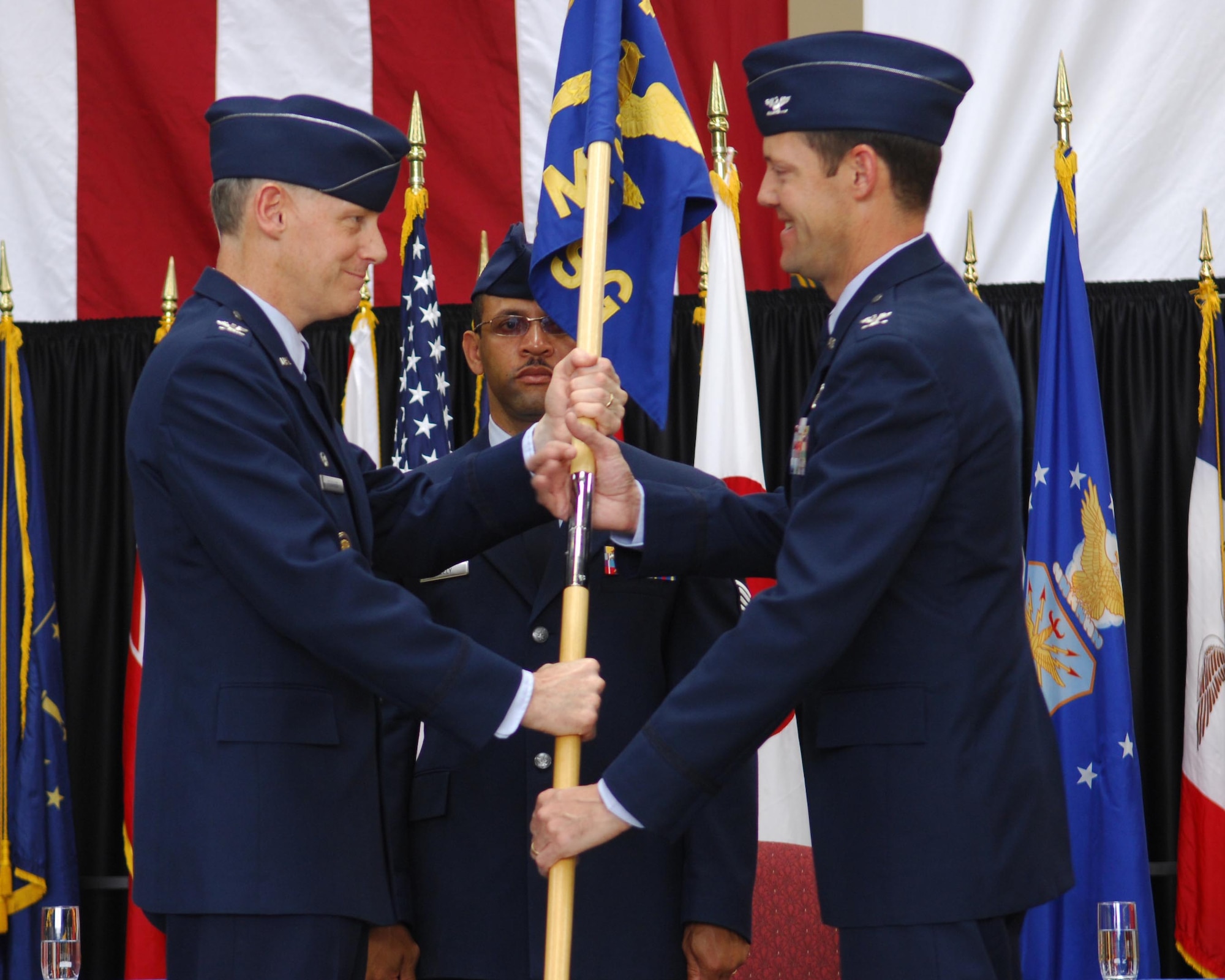 YOKOTA AIR BASE, Japan -- Col. Otto Feather, 374th Airlift Wing commander, passes the guidon to Col. Todd Freece, 374th Mission Support Group commander, during the 374th MSG change of command June 7. Colonel Freece comes to Yokota from Hickam Air Force Base, Hawaii, where he was the vice commander of the 613th Air and Space Operations Center. (U.S. Air Force photo/ Staff Sgt Stacy Moless)