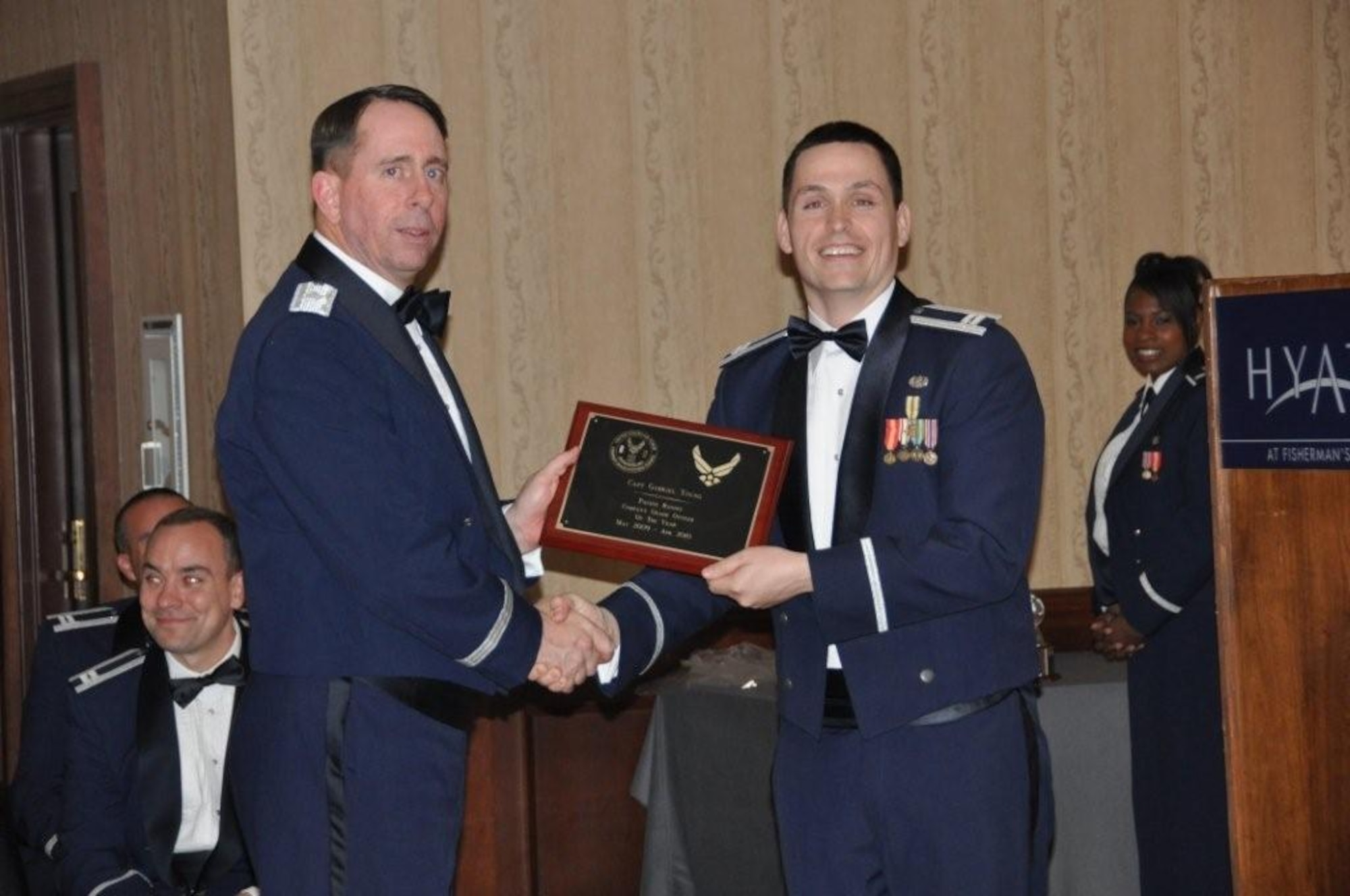 Capt. Gabriel Young, 7 AF/JA, Osan AB, Korea, accepts the PACAF Company Grade Officer of the Year award and Air Force Company Grade Officer of the Year award from Brig. Gen. John Shanahan, 55 WG/CC, Offutt AFB, at a Stars & Bars Dining In held in San Francisco, California.  The award recognizes excellence within the Company Grade Officer's Council.
