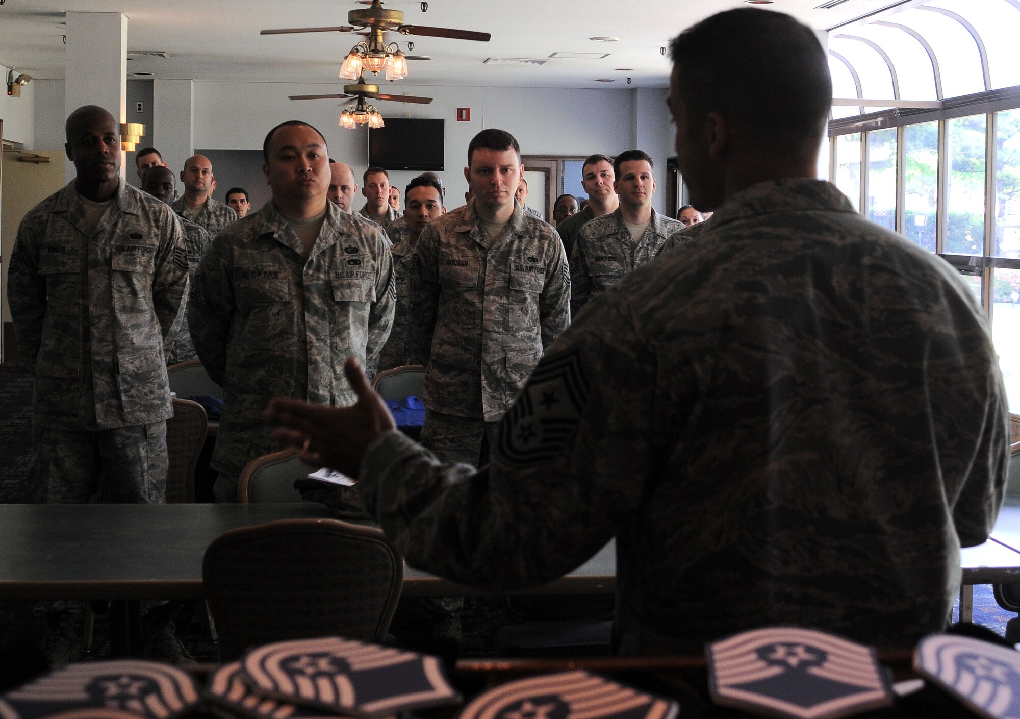 YOKOTA AIR BASE, Japan-- Chief Master Sgt. Benjamin Caro, 374th AW command chief, explains the importance of Senior NCOs to the newest Master Sergeants before a social held at the Enlisted Club here June 4. Forty-one Yokota technical sergeants were among the 5,424 selected May 28 for promotion to master sergeant. (U.S. Air Force Photo/ Airman 1st Class Katrina R. Menchaca)