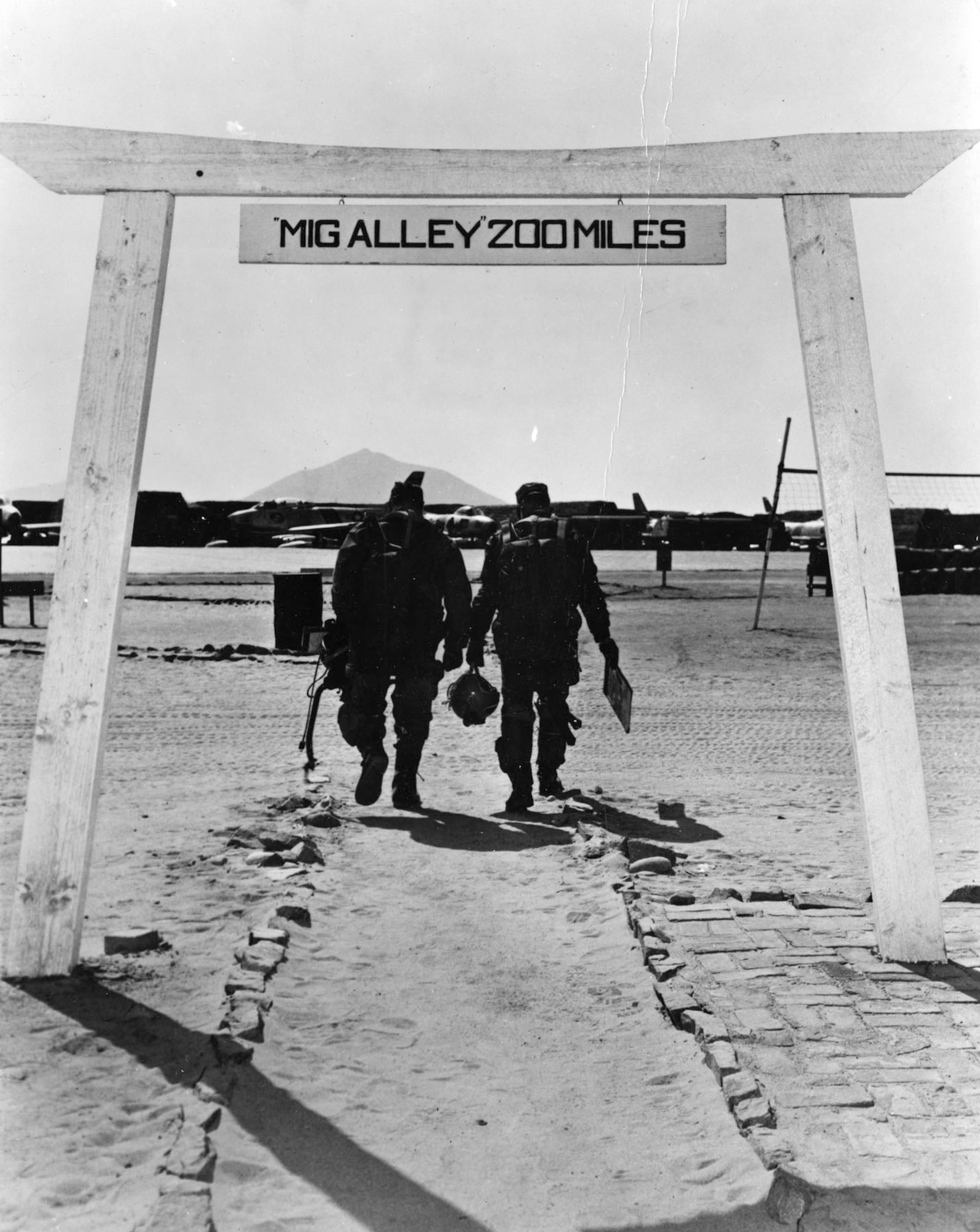 Famous photo of the torii gate leading to the Sabre flight line at Kimpo Air Base. Although torii gates had their origins as entrances to Japanese Shinto shrines, this image has become an enduring symbol of the Air Force during the Korean War. (U.S. Air Force photo)