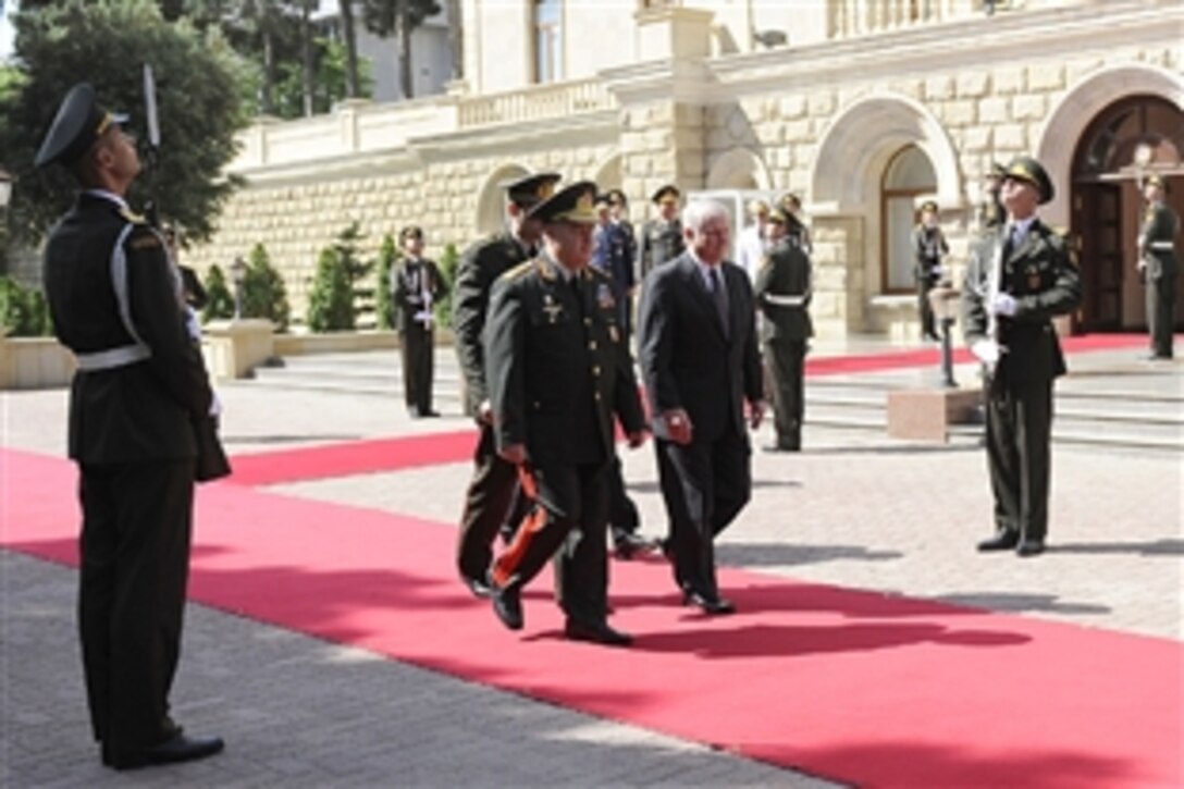 Defense Secretary Robert M. Gates, right, and Azerbaijani Minister of Defense Col. Gen. Safar Akhundbala oglu Abiyev walk out of the Ministry of Defense in Baku, Azerbaijan, June 7, 2010.