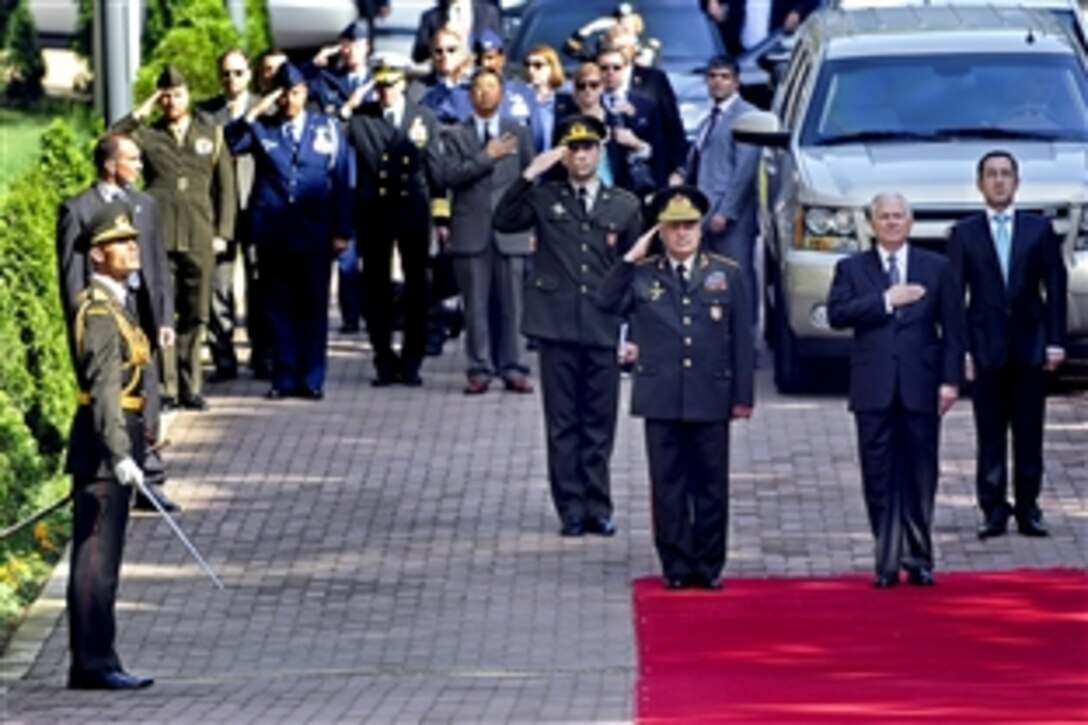 U.S. Defense Secretary Robert M. Gates, right, places his hand over his heart as Azerbaijani Defense Col. Gen. Safar Akhundbala oglu Abiyev salutes during the playing of the U.S. national anthem in Baku, Azerbaijan June 7, 2010.