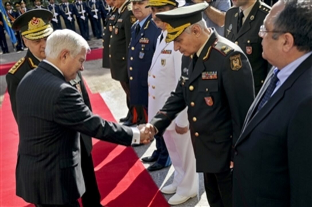 U.S. Defense Secretary Robert M. Gates, left, and Azerbaijani Defense Minister Gen. Col. Safar Akhundbala oglu Abiyev greet staff at the Ministry of Defense in Baku, Azerbaijan, June 7, 2010.