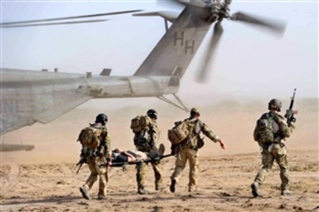 U.S. Air Force pararescuemen transport a simulated casualty to a Marine Corps MH-53 Super Stallion helicopter while conducting a combat search and rescue exercise outside of Camp Lemonier, Djibouti, June 1, 2010.