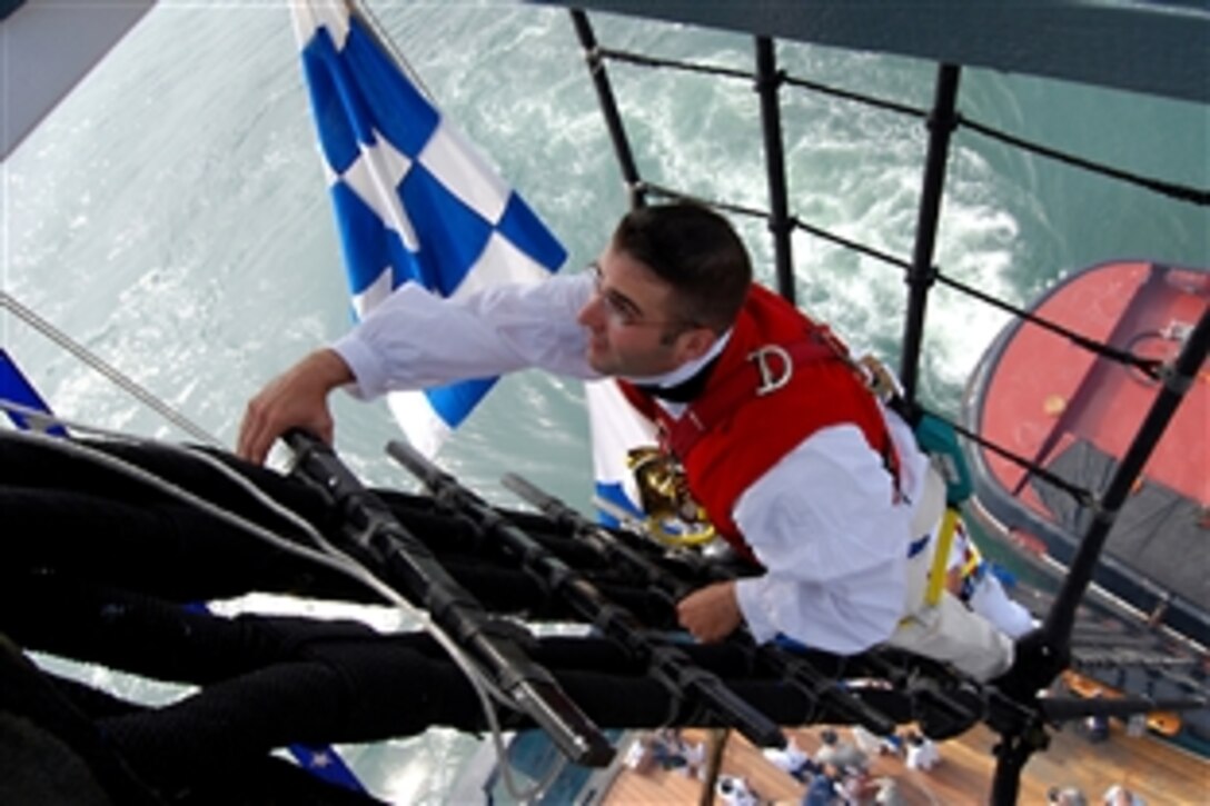 U.S. Navy Chief Petty Officer David Twiford, command master of the USS Constitution, climbs the shrouds of the mizzen mast in Boston, June 4, 2010. The crew of Constitution hosted about 150 members of the Wounded Warrior Project during a Battle of Midway commemoration.