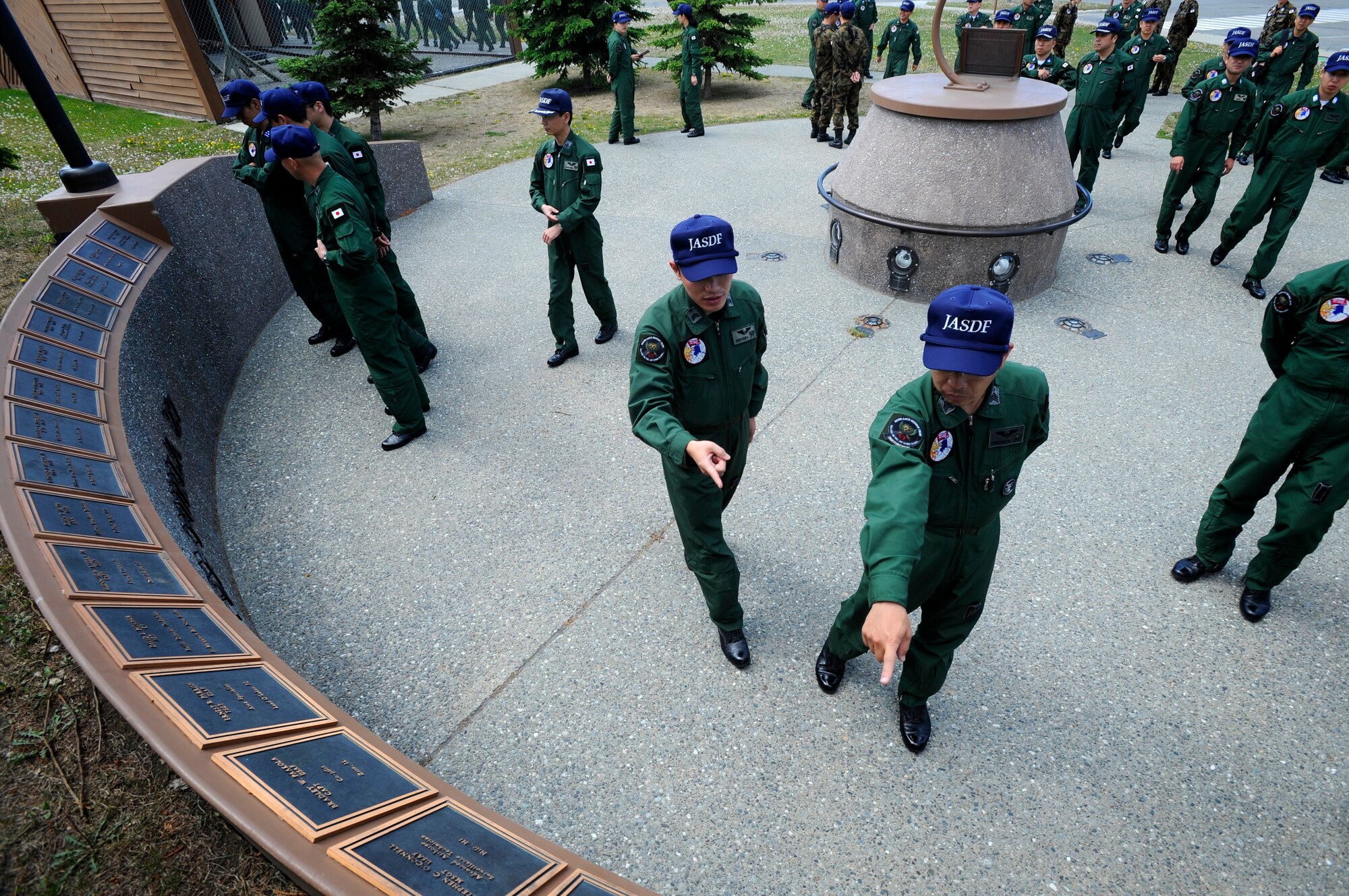Members of the Japanese Air Self Defense Force look at the plaques of fallen Airmen at the Yukla 27 Memorial on Elmendorf Air Force Base, Alaska, June 7. The Yukla 27 Memorial is dedicated in memory to the 24 American and Canadian Airmen who lost their lives in defense of freedom when an E-3B Sentry AWACS from the 962nd Airborne Air Control Squadron crashed after takeoff September 22, 1995.  The Japanese Air Self Defense Force is here participating in Red Flag Alaska 10-3, and pay tribute at the memorial every year. (U.S. Air Force photo/Staff Sgt. Brian Ferguson)