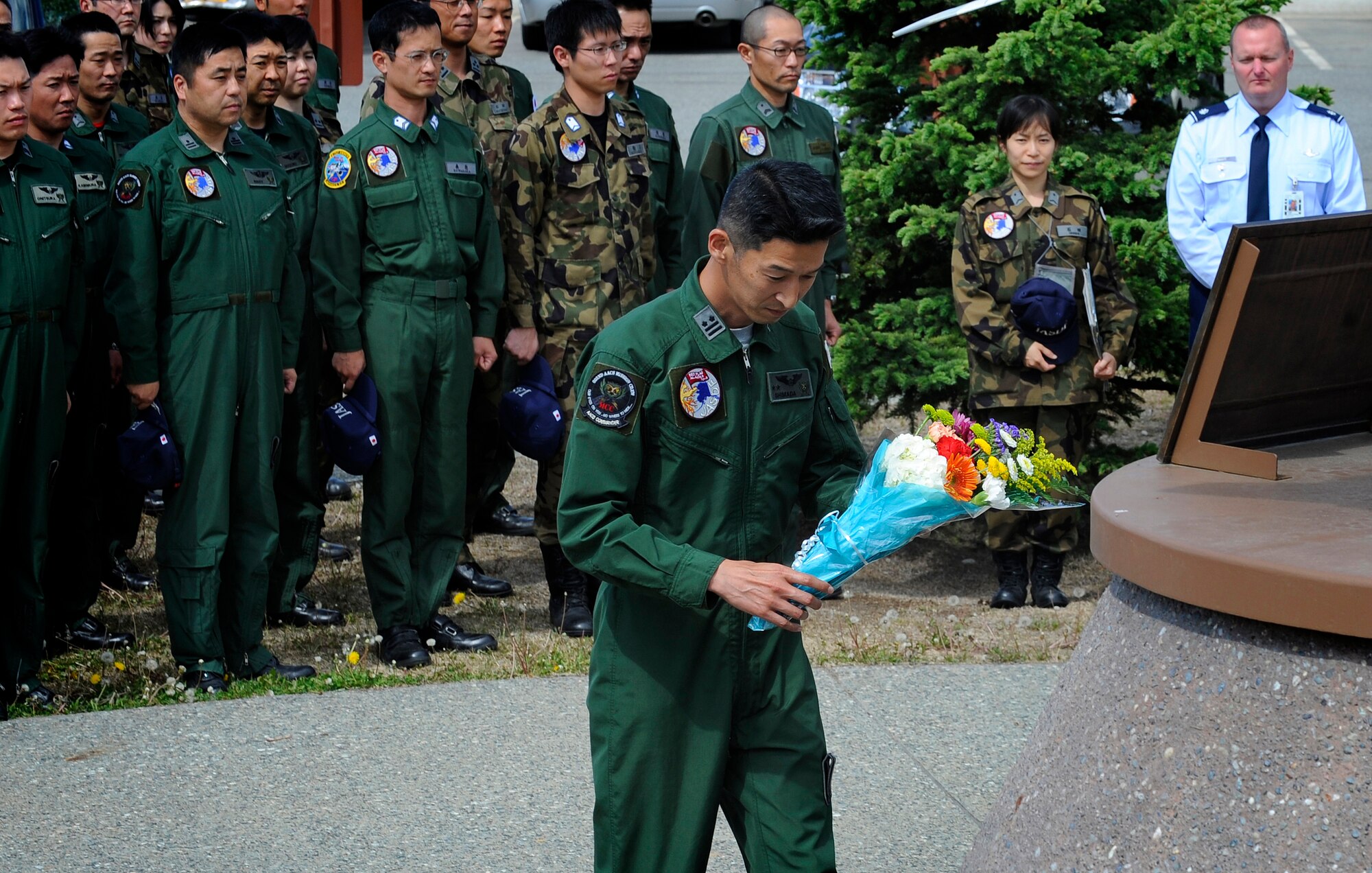 Members of the Japanese Air Self Defense Force pay tribute to fallen Airmen at the Yukla 27 Memorial on Elmendorf Air Force Base, Alaska, June 7. The Yukla 27 Memorial is dedicated in memory to the 24 American and Canadian Airmen who lost their lives in defense of freedom when an E-3B Sentry AWACS from the 962nd Airborne Air Control Squadron crashed after takeoff September 22, 1995.  The Japanese Air Self Defense Force is here participating in Red Flag Alaska 10-3, and pay tribute at the memorial every year. (U.S. Air Force photo/Staff Sgt. Brian Ferguson)