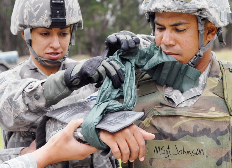 VANDENBERG AIR FORCE BASE, Calif. - Senior Airman Norma Alvarez, of the 30th Security Forces Squadron, applies a splint to Master Sgt. Alvin Johnson, of the 30th Medical Operations Squadron, during a North Star training course at Cocheo Park here Tuesday, June 8, 2010. The training course is designed to train Airmen how to react to various situations during a wartime contingency exercise later in the week as well as in real world situations. (U.S. Air Force photo/Senior Airman Christopher Hubenthal)








