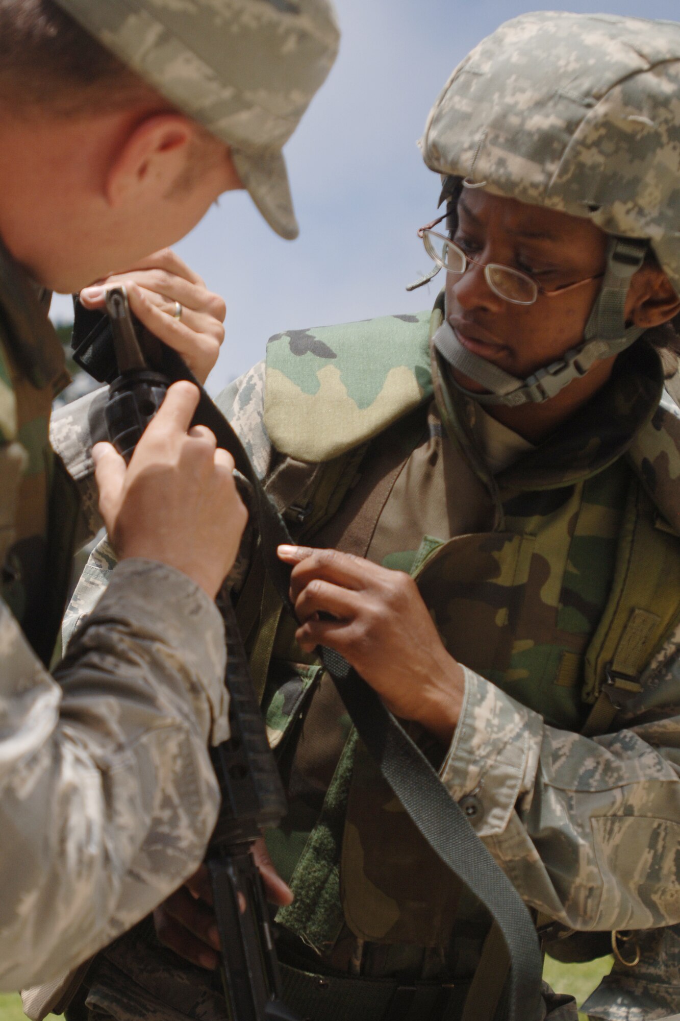 VANDENBERG AIR FORCE BASE, Calif. - Airman 1st Class Tyler Qualls, of the 30th Civil Engineer Squadron, assists Staff Sgt. Tanisha Jordan, of the 30th Operations Support Squadron, during a North Star training exercise at Cocheo Park here Monday, June 7, 2010. The exercise trains Airmen how to react to indirect and direct fire, use sign and countersign, searching and weapon fundamentals. (U.S. Air Force 
photo/Senior Airman Christopher Hubenthal)




