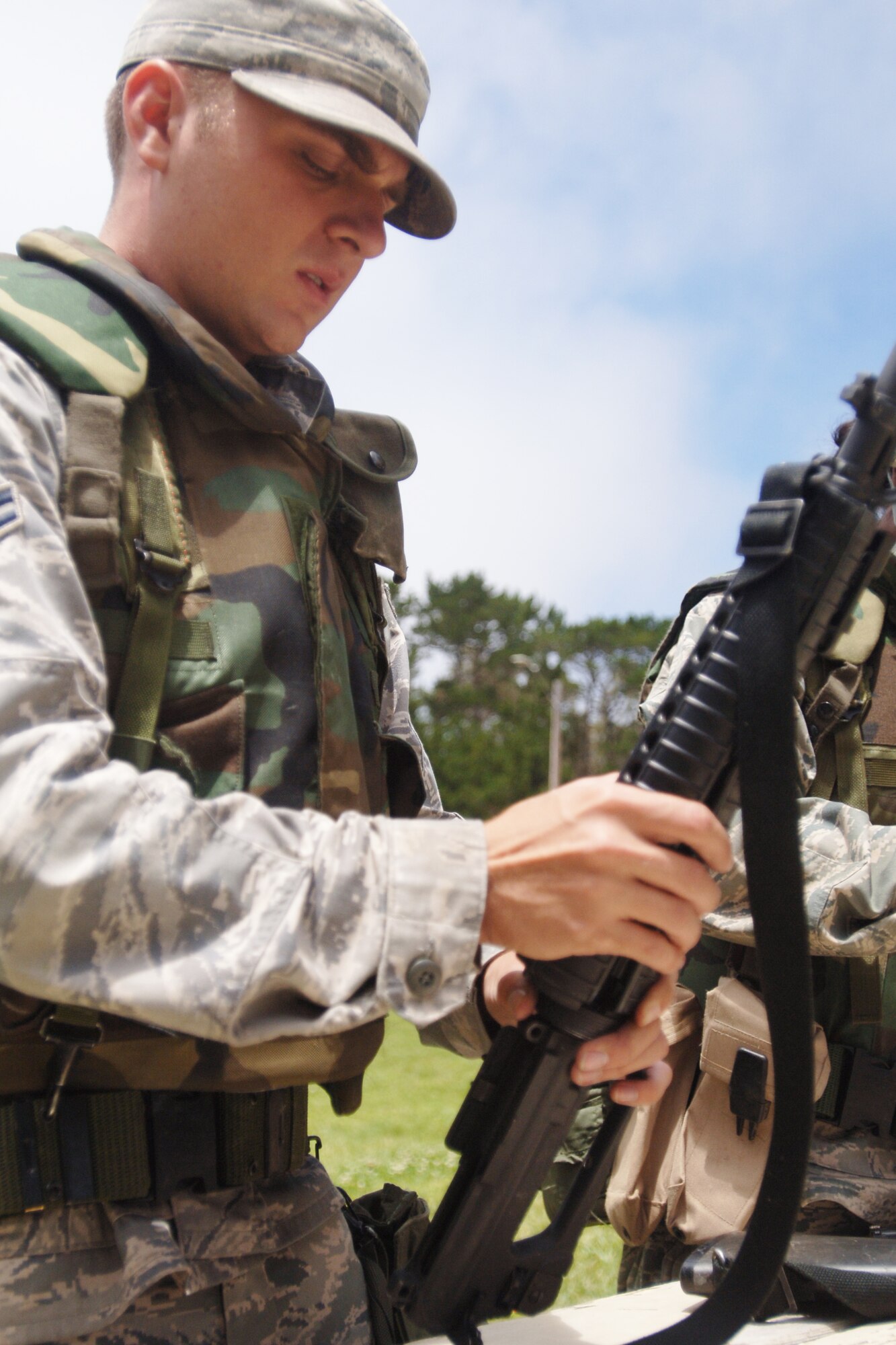 VANDENBERG AIR FORCE BASE, Calif. - Airman 1st Class Tyler Qualls, of the 30th Civil Engineer Squadron,  finishes putting his M16 Rifle back together during Northstar training located at Cocheo Park here Monday, June 7, 2010. The exercise trains Airmen how to react to indirect and direct fire, use sign and countersign, searching and weapon fundamentals. (U.S. Air Force photo/Senior Airman Christopher Hubenthal)



