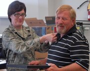 184- Capt. Magnusson pins a medal of appreciation onto Mr. Beard.