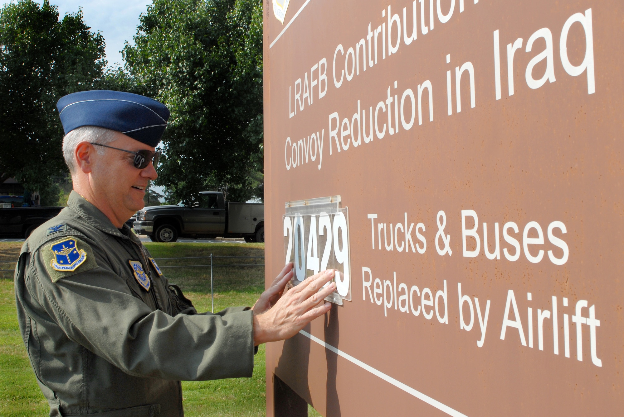 Col. David Kasberg, 19th Operations Group commander, changes the number June 7 of vehicles taken off the road in Iraq to 20,429 due to C-130 combat airlift. The group recently surpassed the 20,000 truck and bus milestone. Throughout the efforts of 19th Airlift Wing Airmen, C-130 aircraft have and will continue to create a safer means of transportation for all branches of the military in Iraq. (U.S. Air Force photo by Senior Airman Steele C. G. Britton)