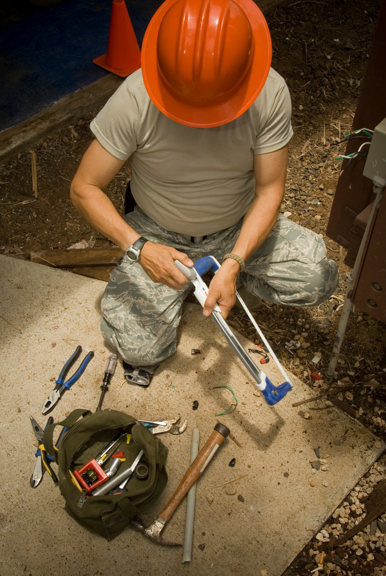 An Airman from the 146th Civil Engineering Squadron Prepares his tools to help with the ongoing construction and renovation of a multi-purpose building at USCG Air Station Barbers Point in Hawaii. The Civil Engineering Squadron was assigned the task of remodeling the muti-purpose building used by Coast Guard Personnel on site. (DoD photo by Airman 1st Class Nicholas Carzis, U.S. Air Force)