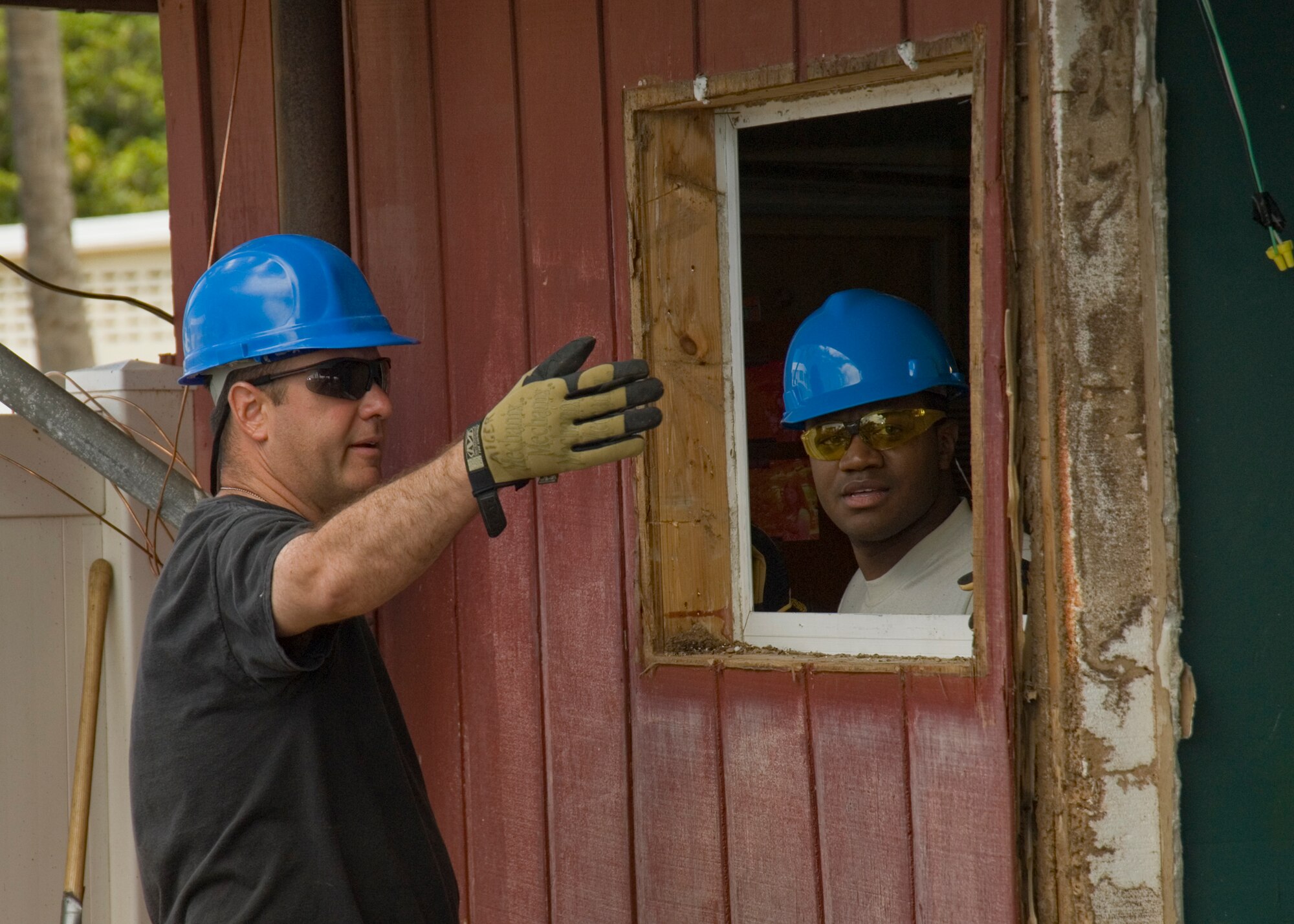 Tech. Sgt. Howard Alger (left) and Senior Airman Kevin Everette (right) from the 146th Civil Engineering Squadron help with the ongoing construction and renovation of a multi-purpose building at USCG Air Station Barbers Point in Hawaii. The Civil Engineering Squadron was assigned the task of remodeling the muti-purpose building used by Coast Guard Personnel on site. (DoD photo by Airman 1st Class Nicholas Carzis, U.S. Air Force)