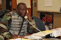 Senior Master Sgt. Tucker, 916th Security Forces, works the Emergency Operations Center telephone during a recent exercise at Volk Field, Wis. (USAF photo by TSgt. Scotty Sweatt, 916ARW/PA).