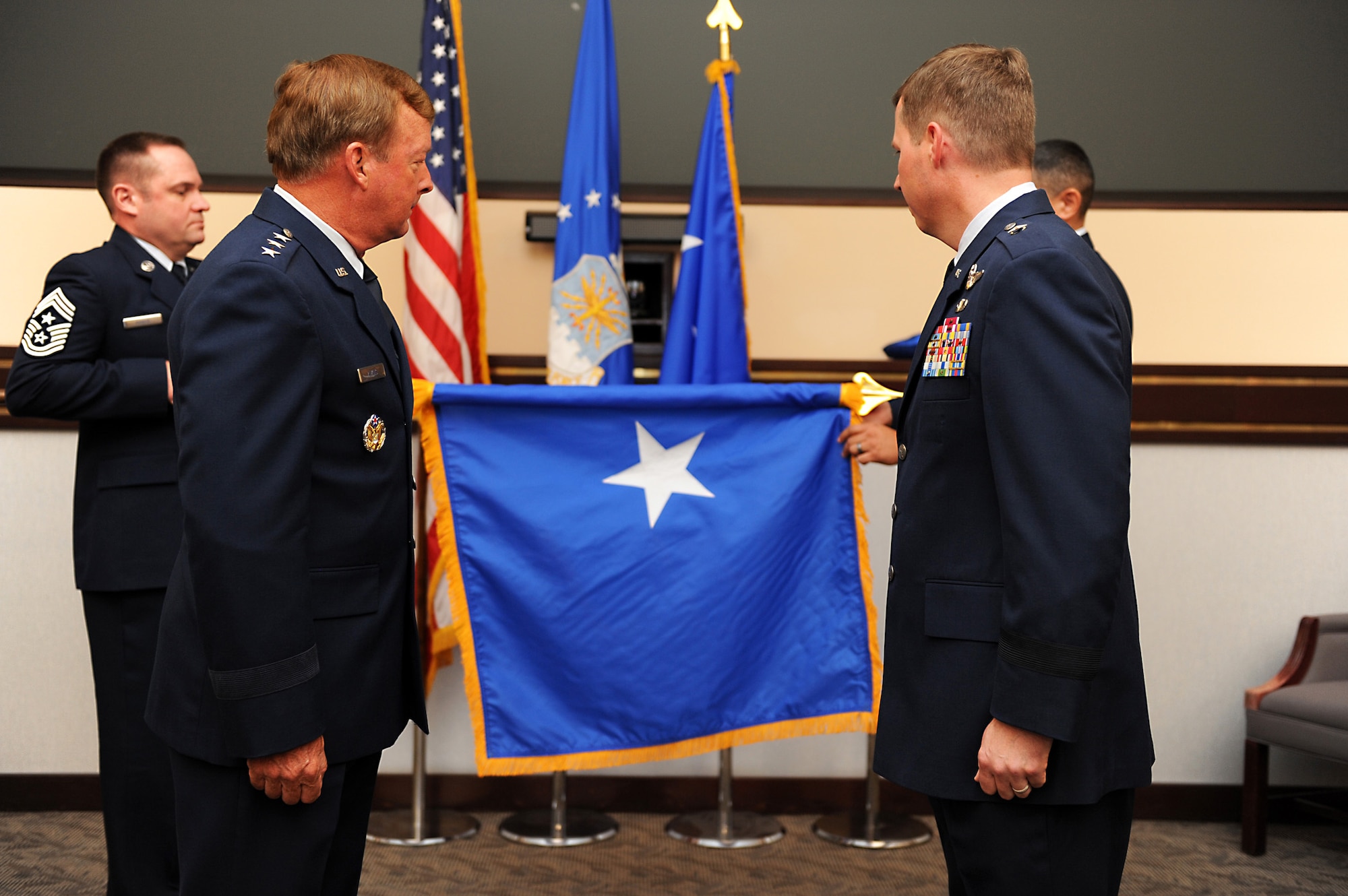 ELMENDORF AIR FORCE BASE, Alaska – Lt. Gen. Dana Atkins, Alaskan Command commander, stands at attention with newly promoted Brig. Gen. Thomas Bergeson, 3rd Wing commander as the brigadier general flag is unrolled. General Bergeson was promoted to the rank of brigadier general June 4. 
