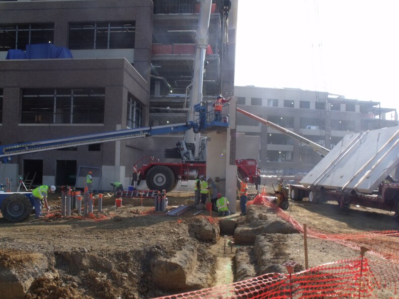 Contractors work to install windows and facade panels on The William A. Jones III Building at Andrews Air Force Base, Md. The five-story office space will replace the aging AFDW Headquarters and provide protected space for military agencies currently leasing offices outisde the gates. Construction is expected to be complete in March, with the first occupants moving in Spring of 2010. 
