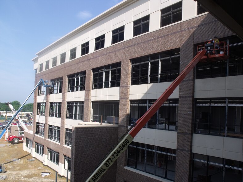 Contractors work to install windows and facade panels on The William A. Jones III Building at Andrews Air Force Base, Md. The five-story office space will replace the aging AFDW Headquarters and provide protected space for military agencies currently leasing offices outisde the gates. Construction is expected to be complete in March, with the first occupants moving in Spring of 2010. 