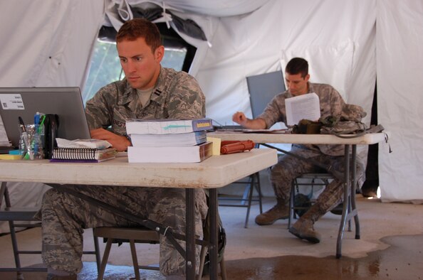 A JAG Flag student researches in preparation for his daily rules of engagement briefing to their commander. JAG Flag trains judge advocates and paralegals to identify and analyze legal and political implications of international military operations, teaches students how to apply legal principles and reinforces the JAG paralegal team concept.
(Air Force photo/Airman 1st Class Chistopher S. Stoltz)
