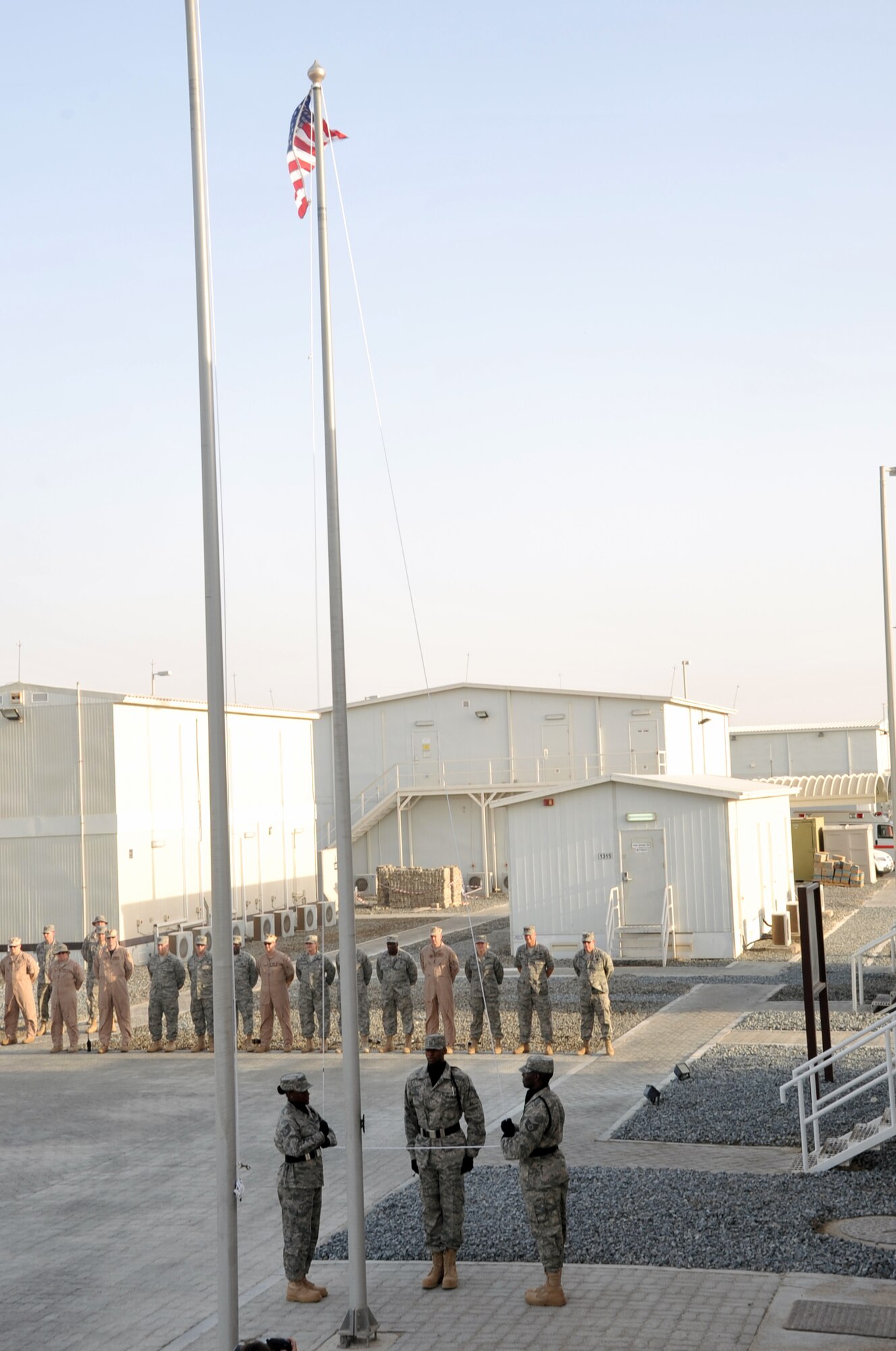 Airmen from the 380th Air Expeditionary Wing participate in a wing retreat ceremony on May 28, 2010, at a non-disclosed base in Southwest Asia. Every week the 380th AEW holds a retreat ceremony honoring the American flag as part of a continuing military tradition. On May 28, the 380th Expeditionary Medical Group served as the lead unit for the retreat. The 380th AEW supports operations Iraqi Freedom and Enduring Freedom and the Combined Joint Task Force-Horn of Africa. (U.S. Air Force Photo/Master Sgt. Scott T. Sturkol/Released)