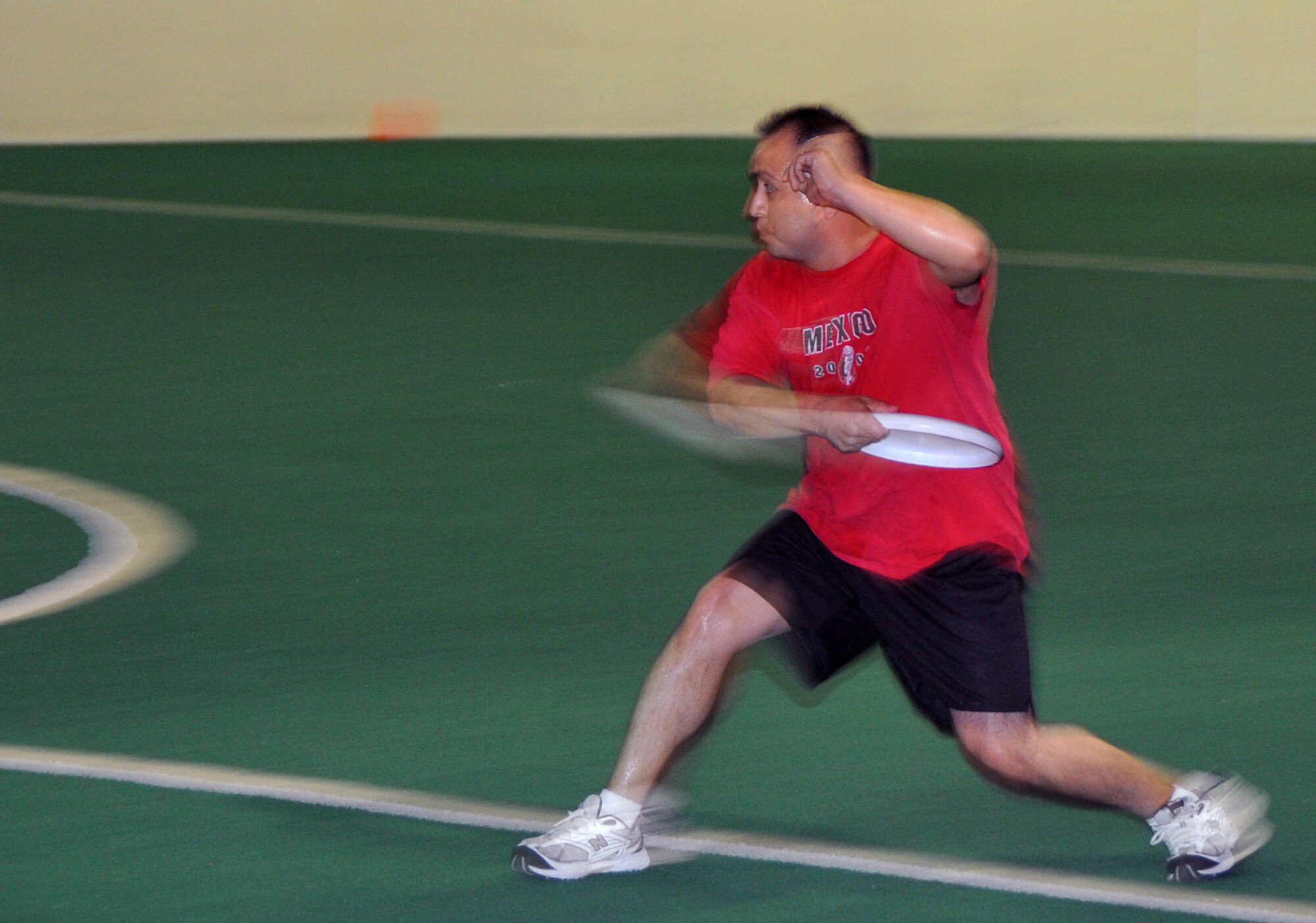 OFFUTT AIR FORCE BASE, Neb. - Staff Sgt. David Gomez from the 55th Medical Group, pulls back to throw a Frisbee during the ultimate Frisbee event at the Offutt Field House during the 55th Wing's annual Sports Day June 4. Sports Day offered many events including volleyball, a 5K race and much more. The event is designed to promote good health and increase unit morale. U.S. Air Force Photo by Jeff W. Gates.
