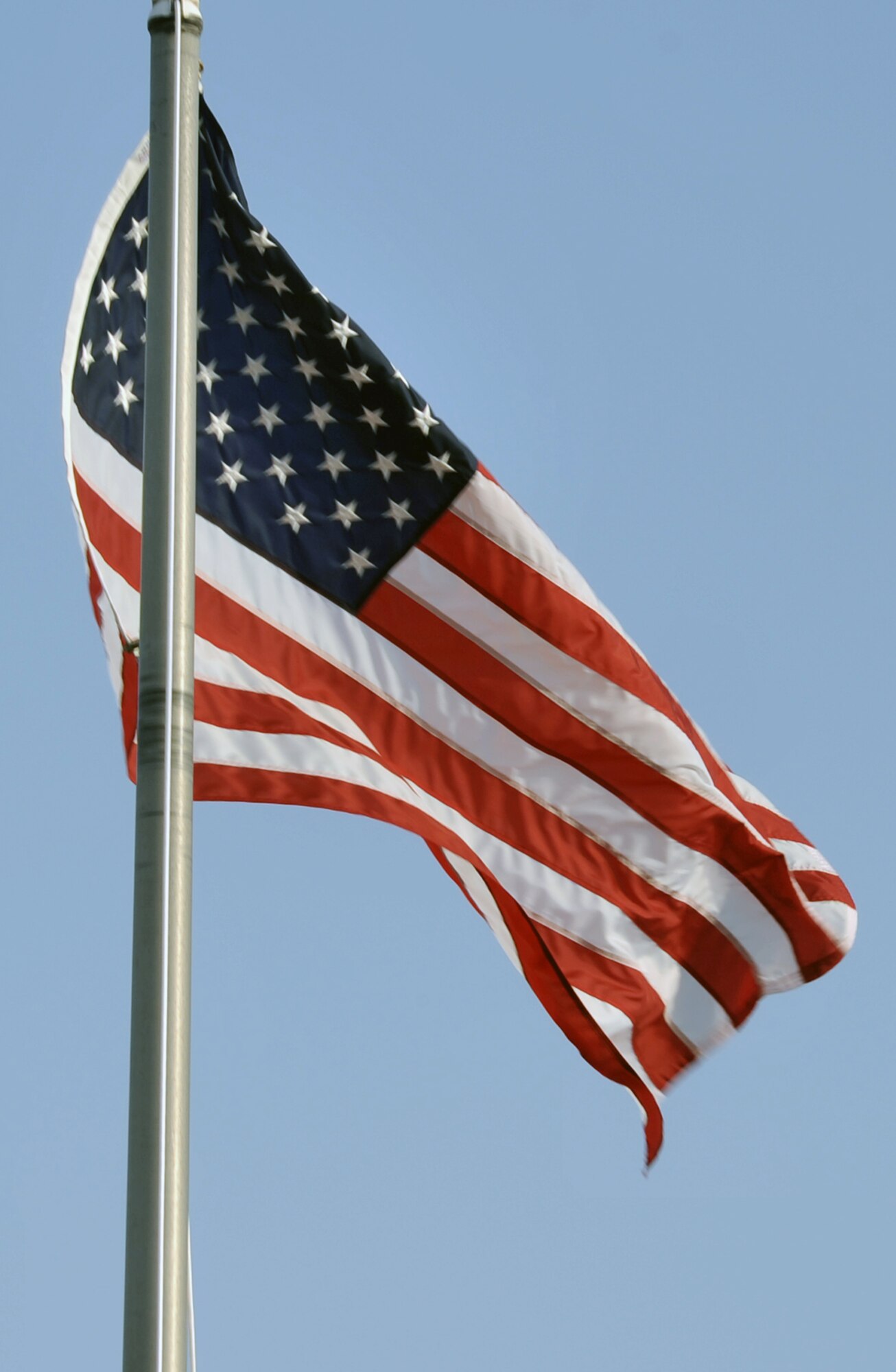 The American flag flies on the wing flagpole as Airmen from the 380th Air Expeditionary Wing participate in a wing retreat ceremony on May 28, 2010, at a non-disclosed base in Southwest Asia. Every week the 380th AEW holds a retreat ceremony honoring the American flag as part of a continuing military tradition. On May 28, the 380th Expeditionary Medical Group served as the lead unit for the retreat. The 380th AEW supports operations Iraqi Freedom and Enduring Freedom and the Combined Joint Task Force-Horn of Africa. (U.S. Air Force Photo/Master Sgt. Scott T. Sturkol/Released)