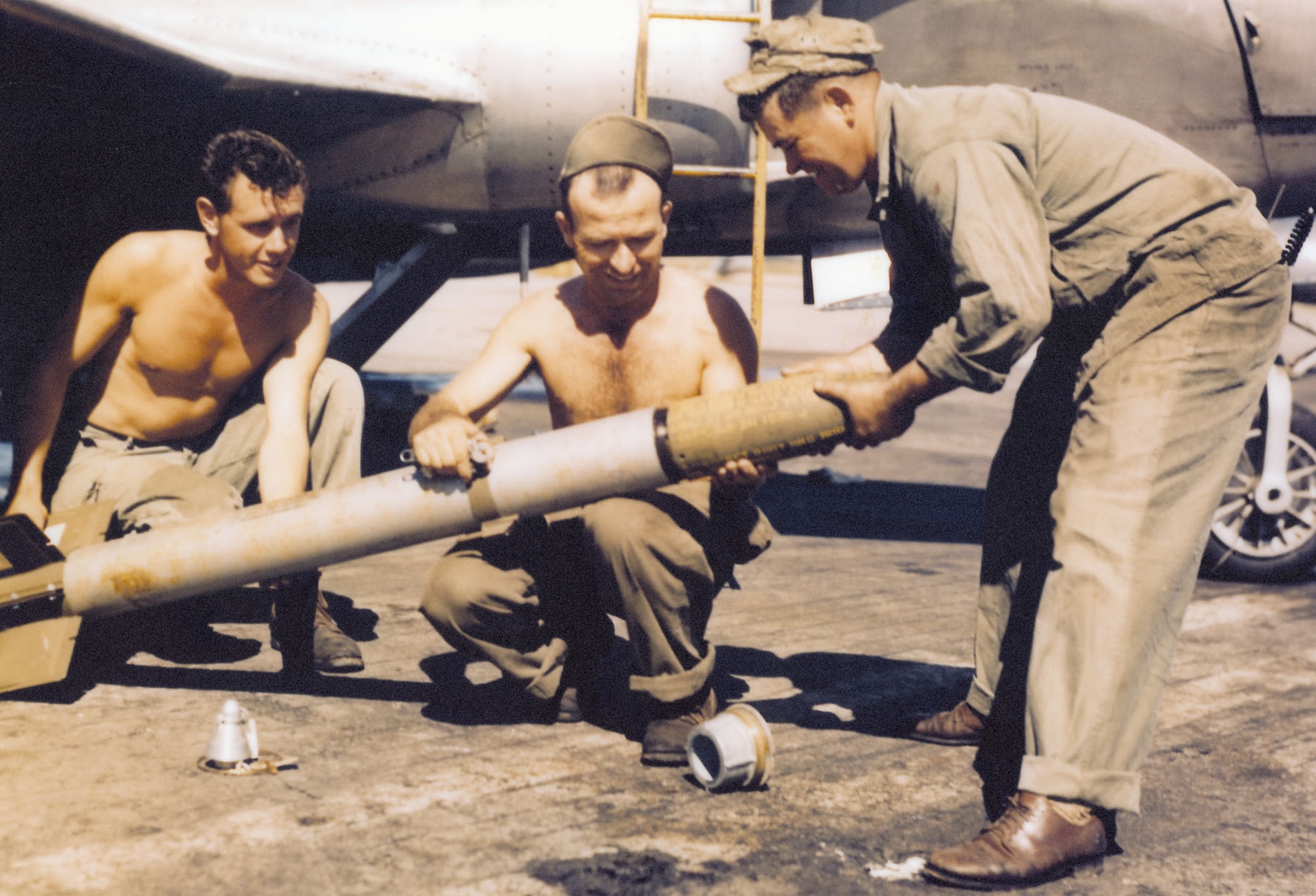 Armorers mount the warhead of an HVAR. (U.S. Air Force photo)