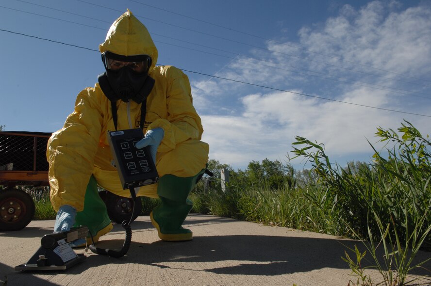 MINOT AIR FORCE BASE, N.D. -- Airman 1st Class Brian Stevens, 5th Civil Engineer Squadron emergency management technician, checks ground radiation levels downwind from an attack in a training scenario during Air Combat Command’s Chemical, Biological, Radiation and Nuclear Equipment Challenge here June 3. The CBRNE challenge employs Airmen in the bioenvironmental and emergency management career fields to apply their combined skills in multiple training scenarios in order to ensure combat readiness.  (U.S. Air Force photo by Senior Airman Michael J. Veloz)