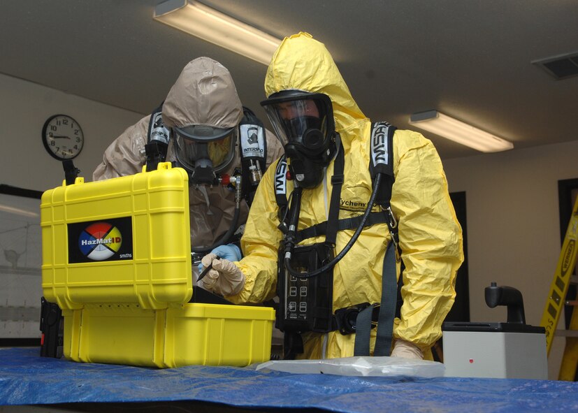 MINOT AIR FORCE BASE, N.D. -- Staff Sgt. Brian Lohr, 5th Medical Operations Squadron bioenvironmental engineering technician and Airman 1st Class Brian Stevens, 5th Civil Engineer Squadron emergency management technician, test hazardous material samples in a training scenario during Air Combat Command’s Chemical, Biological, Radiation and Nuclear Equipment Challenge here June 3. The CBRNE challenge employs Airmen in the bioenvironmental and emergency management career fields to apply their combined skills in multiple training scenarios in order to ensure combat readiness. (U.S. Air Force photo by Senior Airman Michael J. Veloz)