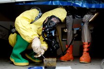 MINOT AIR FORCE BASE, N.D. -- Airman 1st Class Brian Stevens, 5th Civil Engineer Squadron emergency management technician, extracts a specimen for testing in a training scenario during Air Combat Command’s Chemical, Biological, Radiation and Nuclear Equipment Challenge here June 3. The CBRNE challenge employs Airmen in the bioenvironmental and emergency management career fields to apply their combined skills in multiple training scenarios in order to ensure combat readiness. (U.S. Air Force photo by Senior Airman Michael J. Veloz)