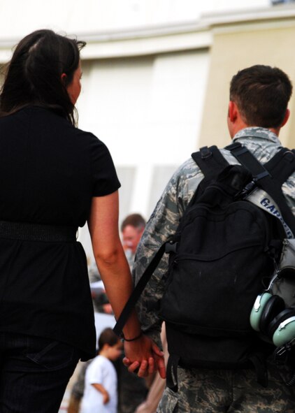 A 919th Special Operations Wing war returnee and his wife head for home moments after his arrival at Eglin Air Force Base, Fla., June 6. More than 70 Airmen from Duke Field returned home from their deployment June 5 and 6. Friends, family, co-workers and community leaders came out to greet them and welcome the Airmen home. (U.S. Air Force photo/TSgt. Cheryl Foster) 