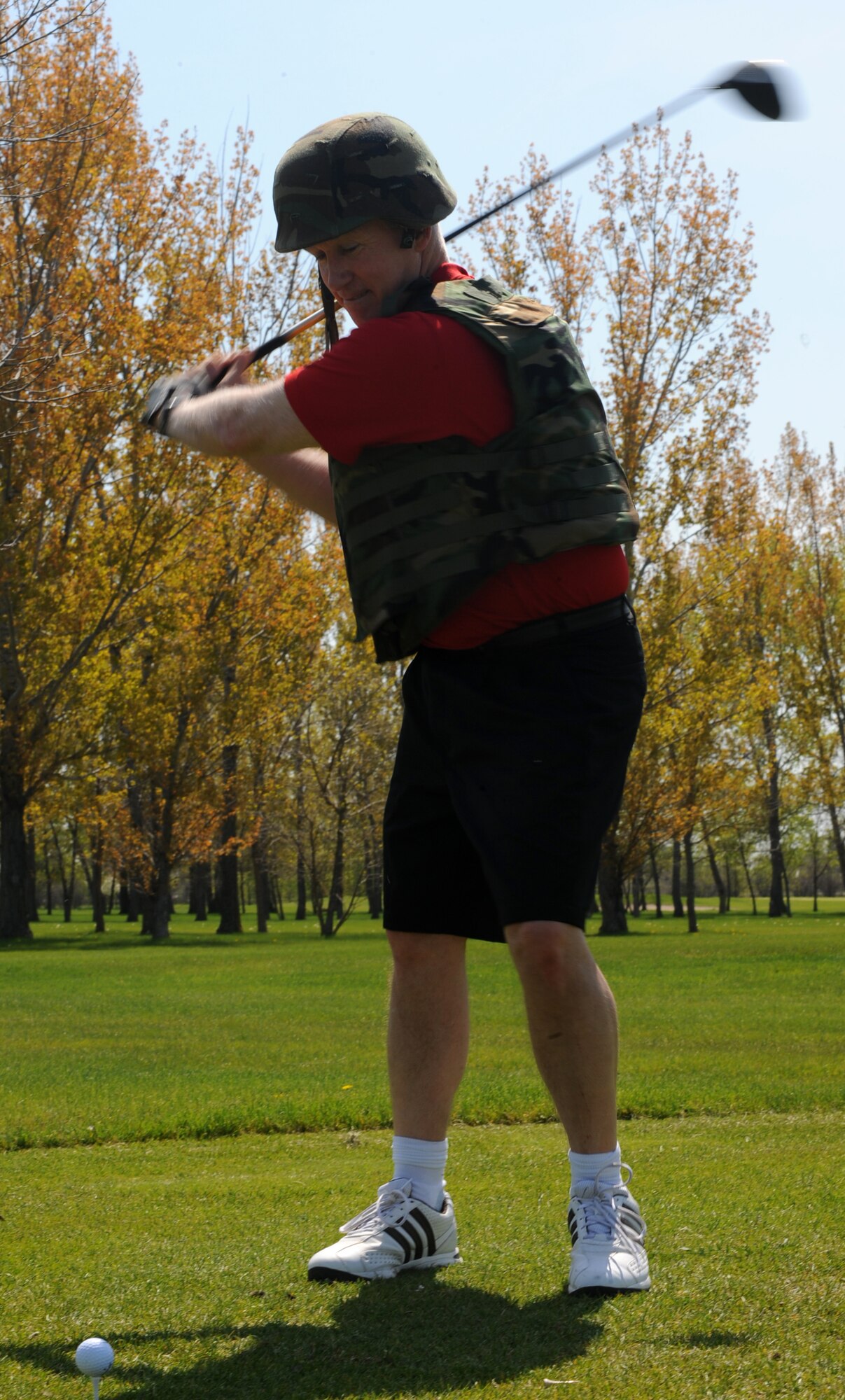 Col. Joseph Douez, 319th Mission Support Group commander, dressed in full battle-rattle, tees off during the 319th Security Forces Golf Tournament, May 14 that was held for the National Police Week at the Plainsview golf course here. The tournament consisted of four-person teams, playing 18-holes and the lowest scoring team wins. The tournament consisted of four-person teams, each participant played 18-holes and the team with the lowest combined score wins. (U.S. Air Force photo by Airman 1st Class Amber Price)