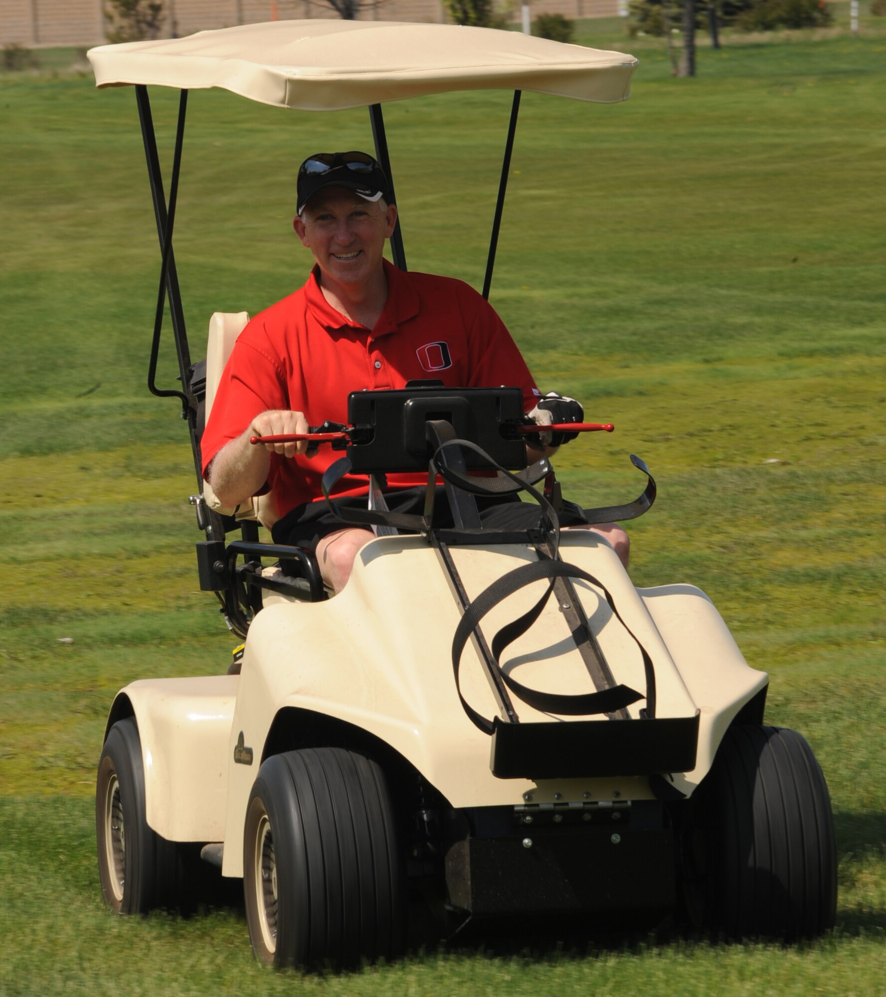Col. Joseph Douez, 319th Mission Support Group commander, arrives to the tee box in style before the start of the 319th Security Forces Golf Tournament, May 14 that was held for the National Police Week at the Plainsview golf course here. The tournament consisted of four-person teams, each participant played 18-holes and the team with the lowest combined score wins. (U.S. Air Force photo by Airman 1st Class Amber Price)
