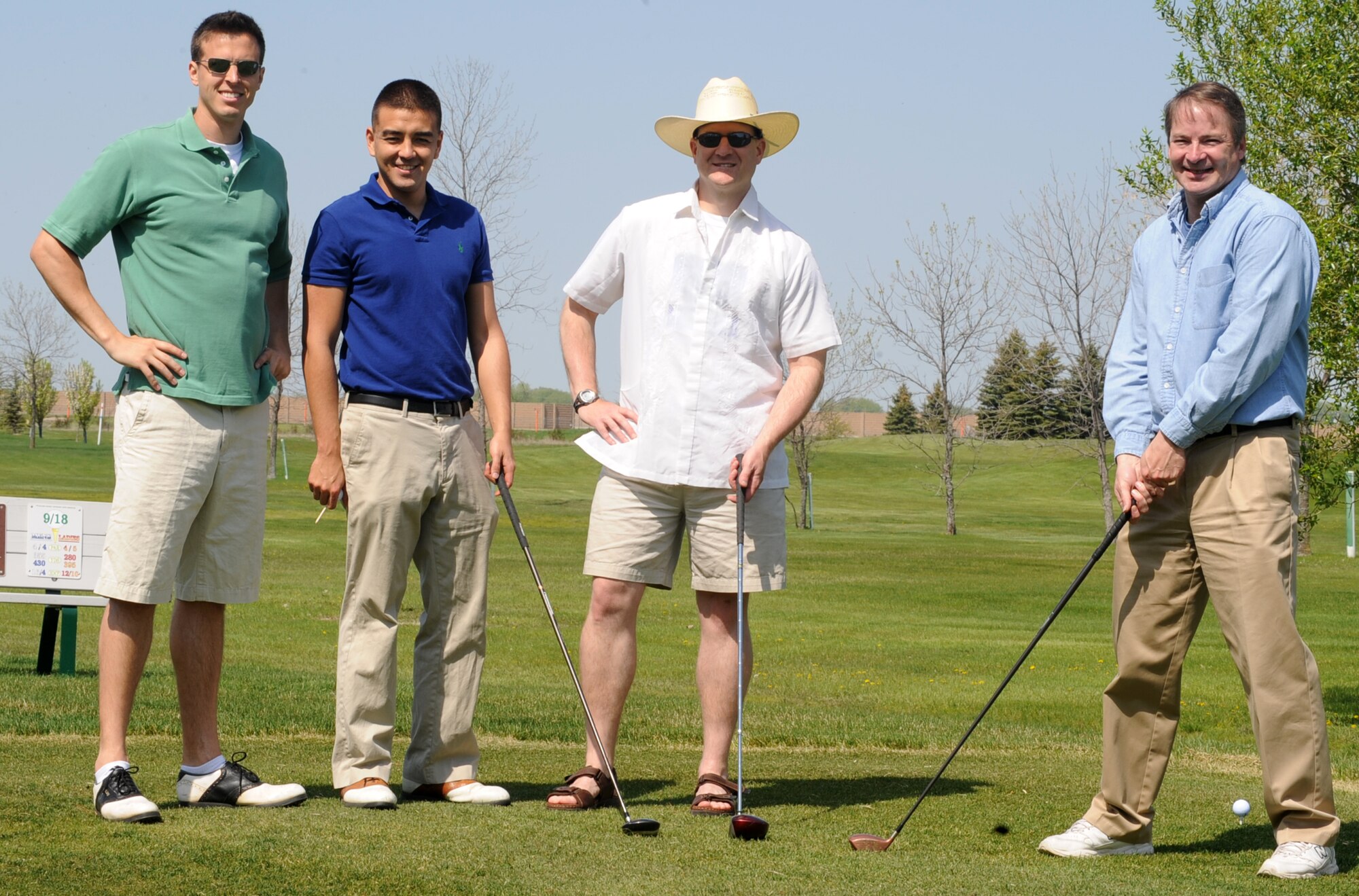 Capt. John Bone, Capt. Ian Holzhauer, Lt. Col. Scott Harding and Mr. Mark Hanson (from left to right) all with the 319th Air Refueling Wing Office of the Staff Judge Advocate, pose for a group picture before participating in the 319th Security Forces Golf Tournament, May 14 that was held for the National Police Week at the Plainsview golf course here. The tournament consisted of four-person teams, each participant played 18-holes and the team with the lowest combined score wins. (U.S. Air Force photo by Airman 1st Class Amber Price)