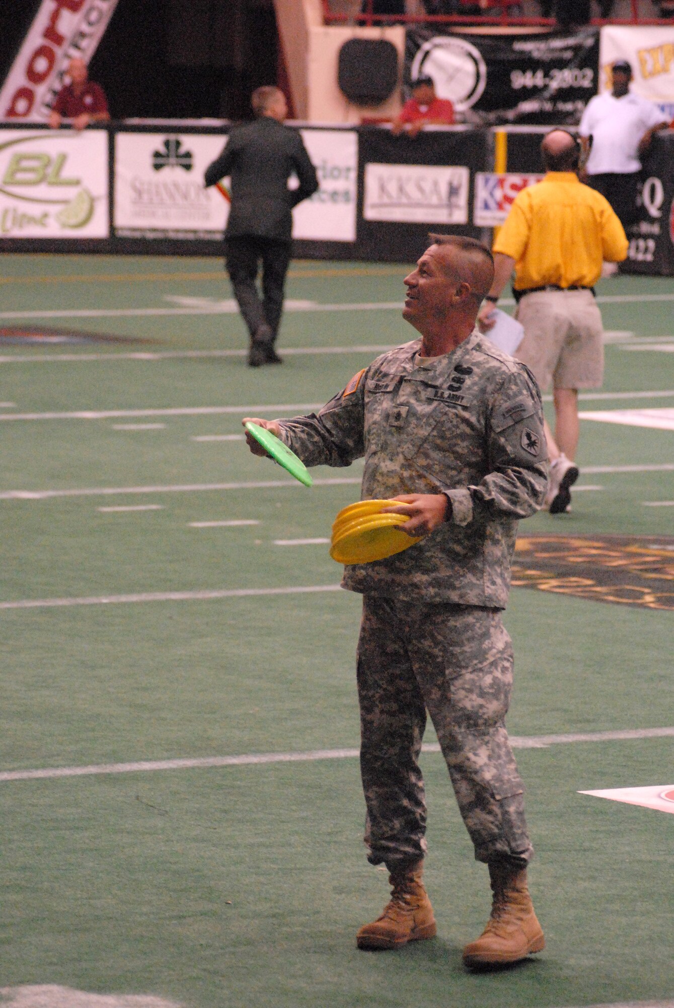 Command Sergeant Major Dan McCraw, 344th Military Intelligence Battalion, helps throw out Frisbees during a break in the San Angelo Stampede Express Indoor Football League game June 5.  The Stampede honored military members with a military appreciation night. (U.S. Air Force photo/ Master Sgt. Randy Mallard)