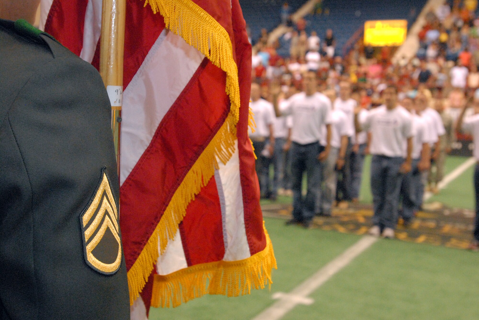 A group of young men and women enlist into the Texas Army National Guard during halftime at the San Angelo Stampede Express Indoor Football League game June 5.  The Stampede honored military members with a military appreciation night. (U.S. Air Force photo/ Master Sgt. Randy Mallard)