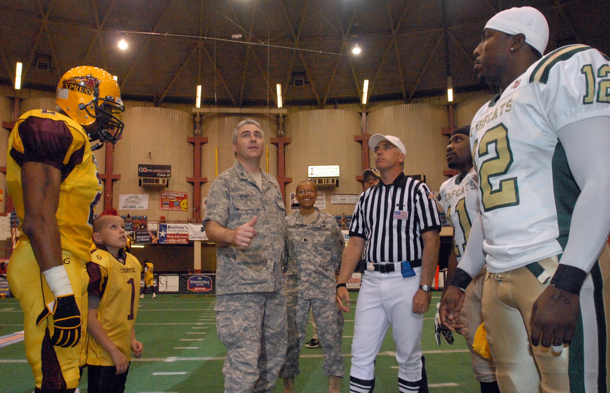 Col. Thomas Geary, 17th Training Wing Commander, flips a wing coin at the beginning of the San Angelo Stampede Express vs. the Austin Turfcats June 5. The Stampede Express honored military members with a military appreciation night. (U.S. Air Force photo/ Master Sgt. Randy Mallard)