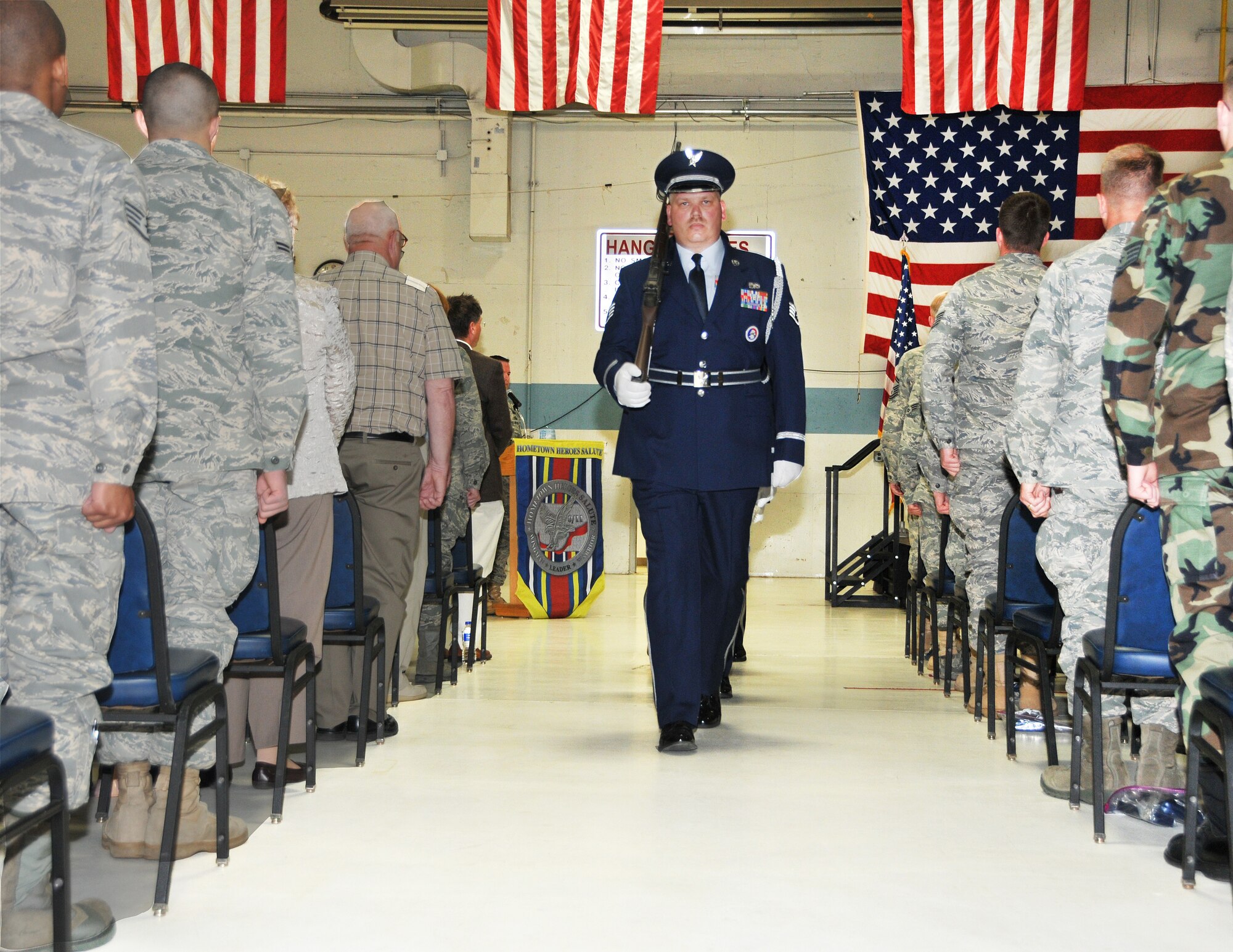 Staff Sgt. Bob Garrelts, Volk Field Honor Guard team member and member of the 128th Air Control Squadron, leads the Color Guard after playing of the National Anthem during the Hometown Heroes Celebration at Volk Field May 1. The ceremony paid tribute to more than 150 Airmen of the 128th ACS and Combat Readiness Training Center for their sacrifices and deployed support around the globe since Sept. 11, 2001. Wisconsin National Guard photo by Tech. Sgt. Jon LaDue