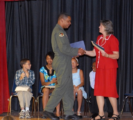 Libbie Pippin, Tyndall Elementary School principal (right) extends her thanks to Maj. Gen. Garry C. Dean, 1st Air Force commander, for delivering a keynote speech during the school’s 5th Grade Recognition Ceremony June 4, 2010.  Seen in the background are Brandon Oncale, Adora Walker, Ashley Kennedy, and Diy’Quon Roulhac.