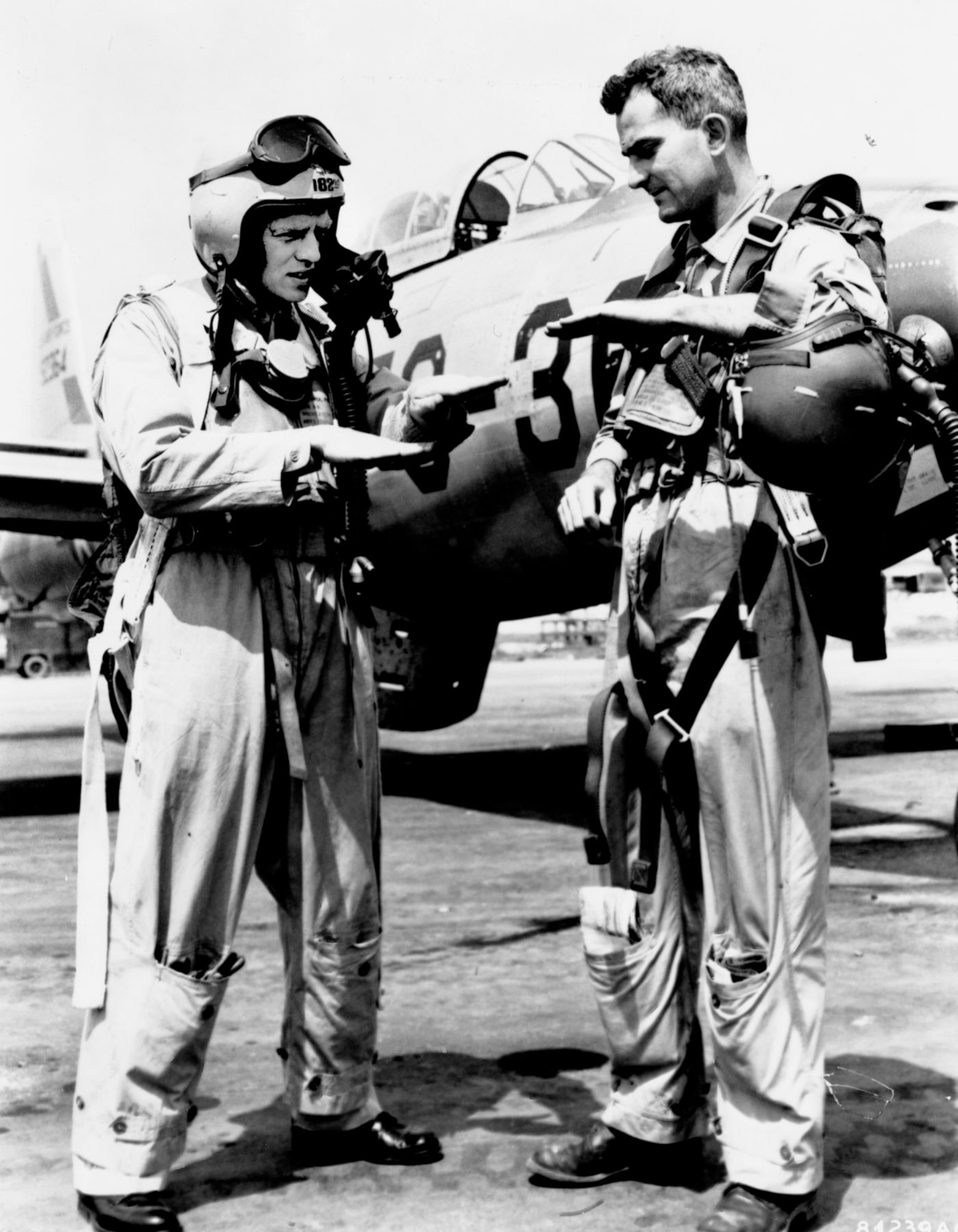 Texas Air National Guard pilots 1st Lt. Arthur Oligher (left) and Capt. Harry Underwood of the 182nd Fighter-Bomber Squadron, 136th Fighter-Bomber Wing, discuss downing a MiG-15 jet. Flying F-84s, their combined kill on June 26, 1951, was the first jet combat victory for Air Guard pilots. (U.S. Air Force photo)