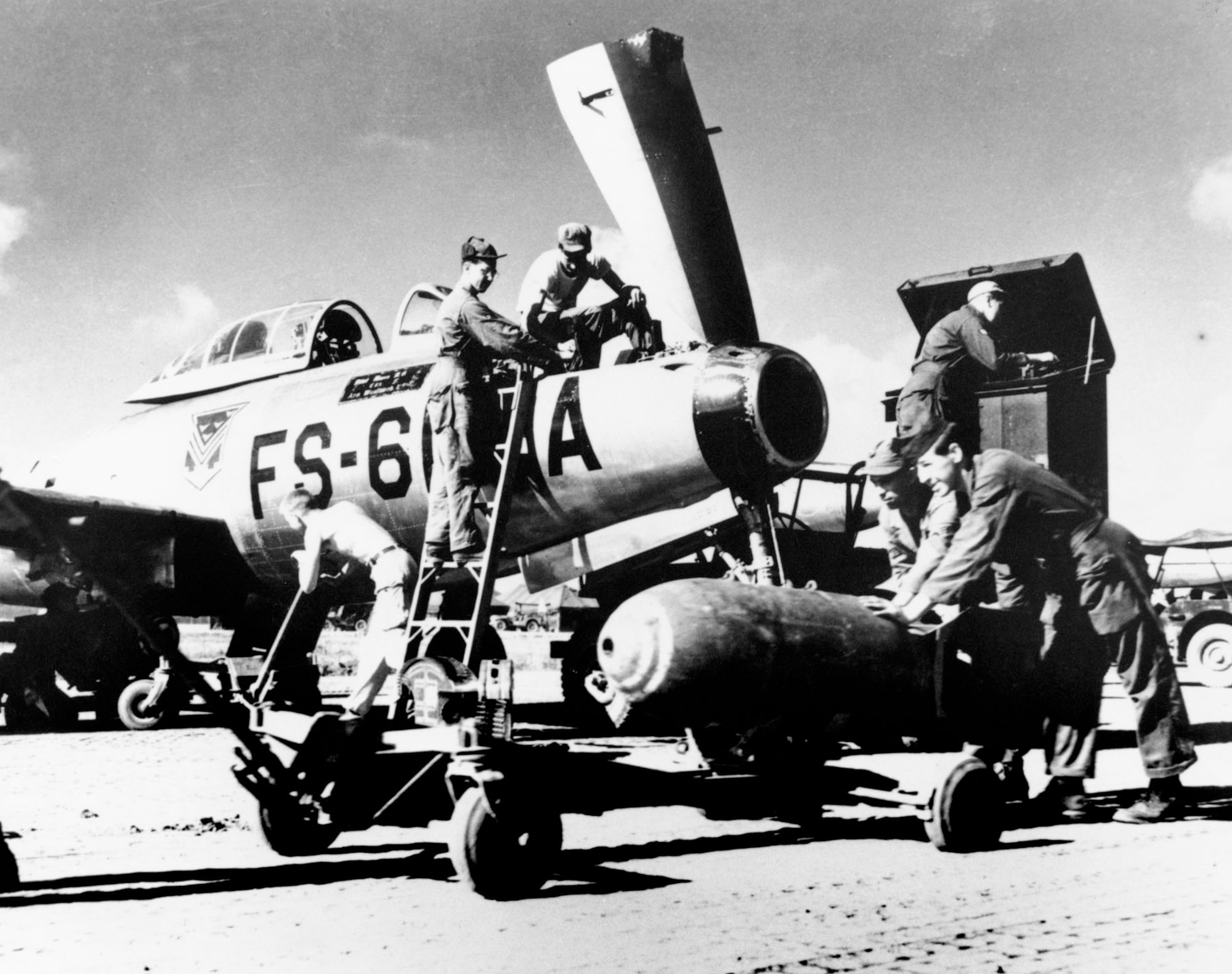 Ground crewmen from the Florida Air National Guard’s 159th Fighter Squadron ready an F-84 for combat in Korea. (U.S. Air Force photo)