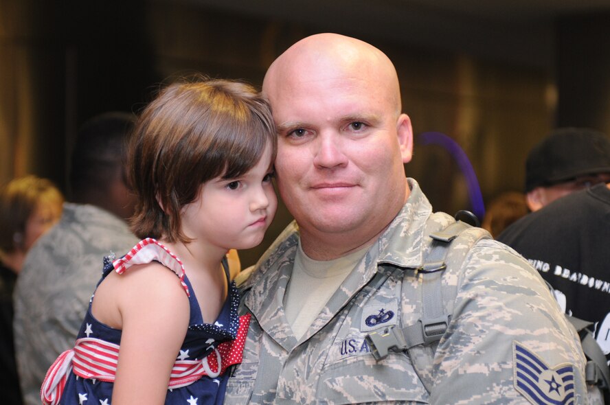 Tech. Sgt.  Michael Royval is welcomed home after a five-month deployment to Iraq, June 6. Family and friends celebrated the return of 29 security forces Airmen assigned to the 162nd Fighter Wing at Tucson International Airport. (Air Force photo by Maj. Gabe Johnson)