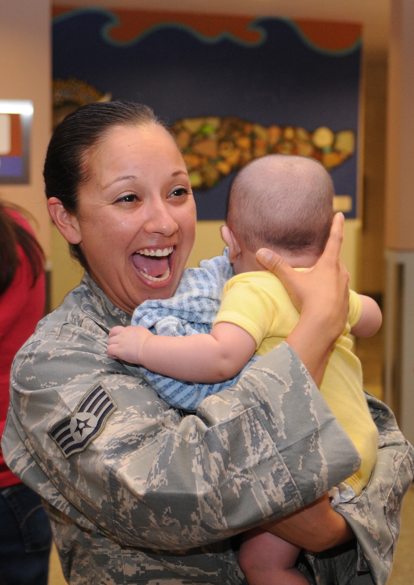 Staff Sgt. Melissa Ballesteros is welcomed home after a five-month deployment to Iraq, June 6. Family and friends celebrated the return of 29 security forces Airmen assigned to the 162nd Fighter Wing at Tucson International Airport. (Air Force photo by Maj. Gabe Johnson)