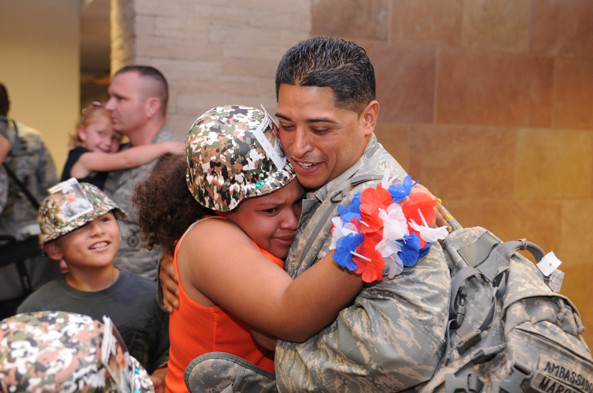 Tech. Sgt. Ernesto Marquez is welcomed home after a five-month deployment to Iraq, June 7. Family and friends celebrated the return of 29 security forces Airmen assigned to the 162nd Fighter Wing at Tucson International Airport. (Air Force photo by Maj. Gabe Johnson)