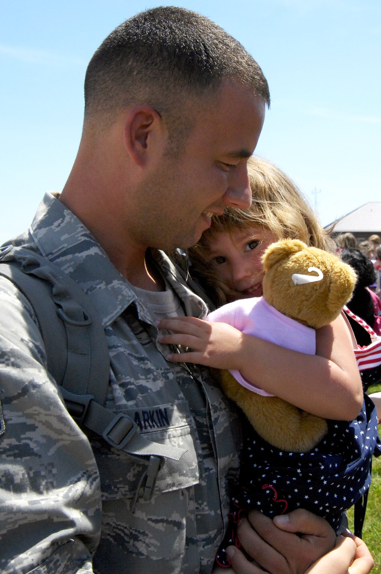 WHITEMAN AIR FORCE BASE, Mo. - Staff Sgt. Nicholas Larkin, 509th Munitions Squadron, holds his daughter, Laney, June 4 after returning from a four-month deployment to Andersen AFB, Guam. More than 200 Airmen deployed in support of the B-2 Spirit's continuing bomber presence in the Pacific. (U.S. Air Force photo/Senior Airman Jason Barebo)